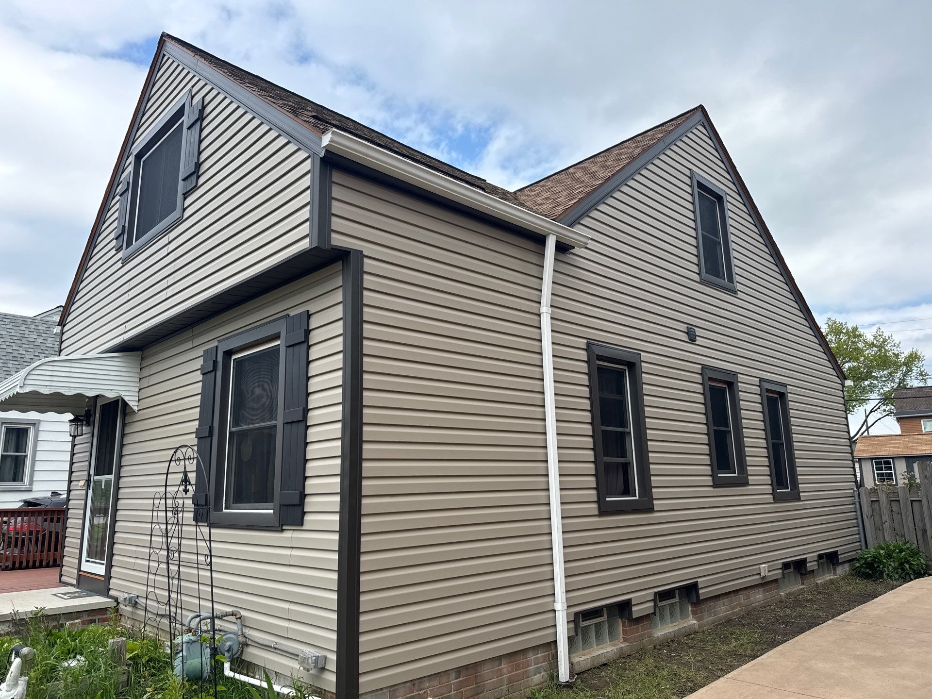 Full Exterior Siding and Awning Transformation in Parma by Cornerstone Roofing And Siding