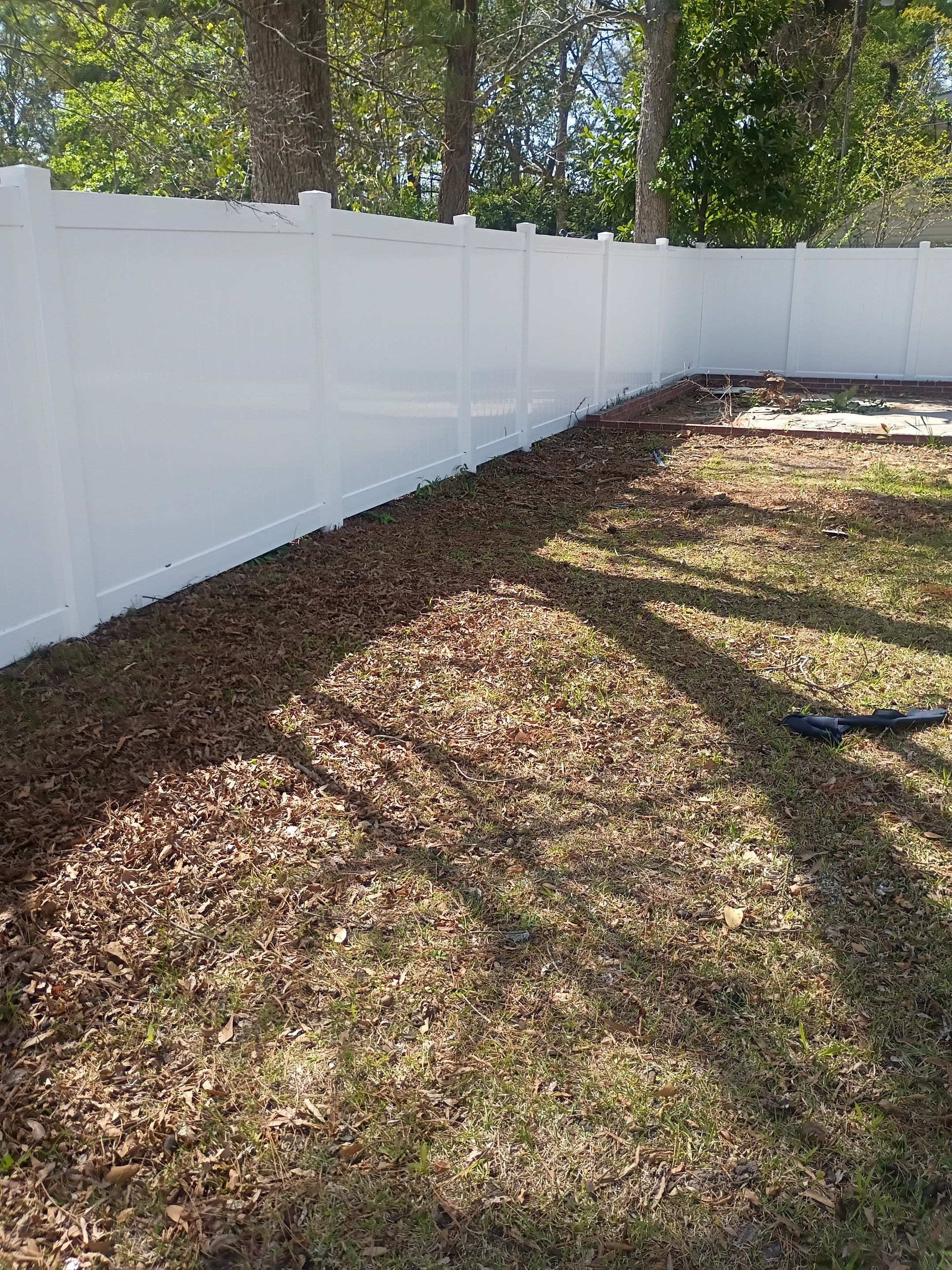 White Vinyl Privacy Fence Installation in Greenville, NC by Superior Fence and Rail