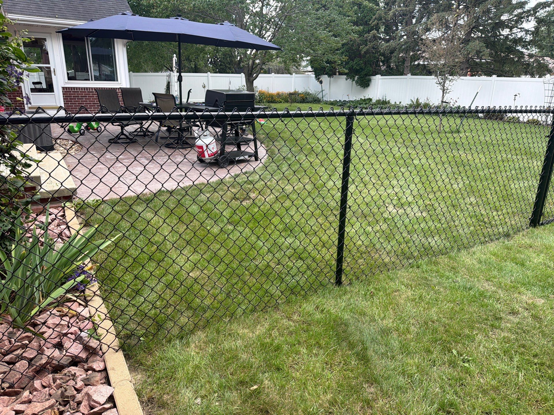 Residential White Vinyl Privacy and Black Chain Link Fencing in Jesup by Perfect Picket Fence and Stain