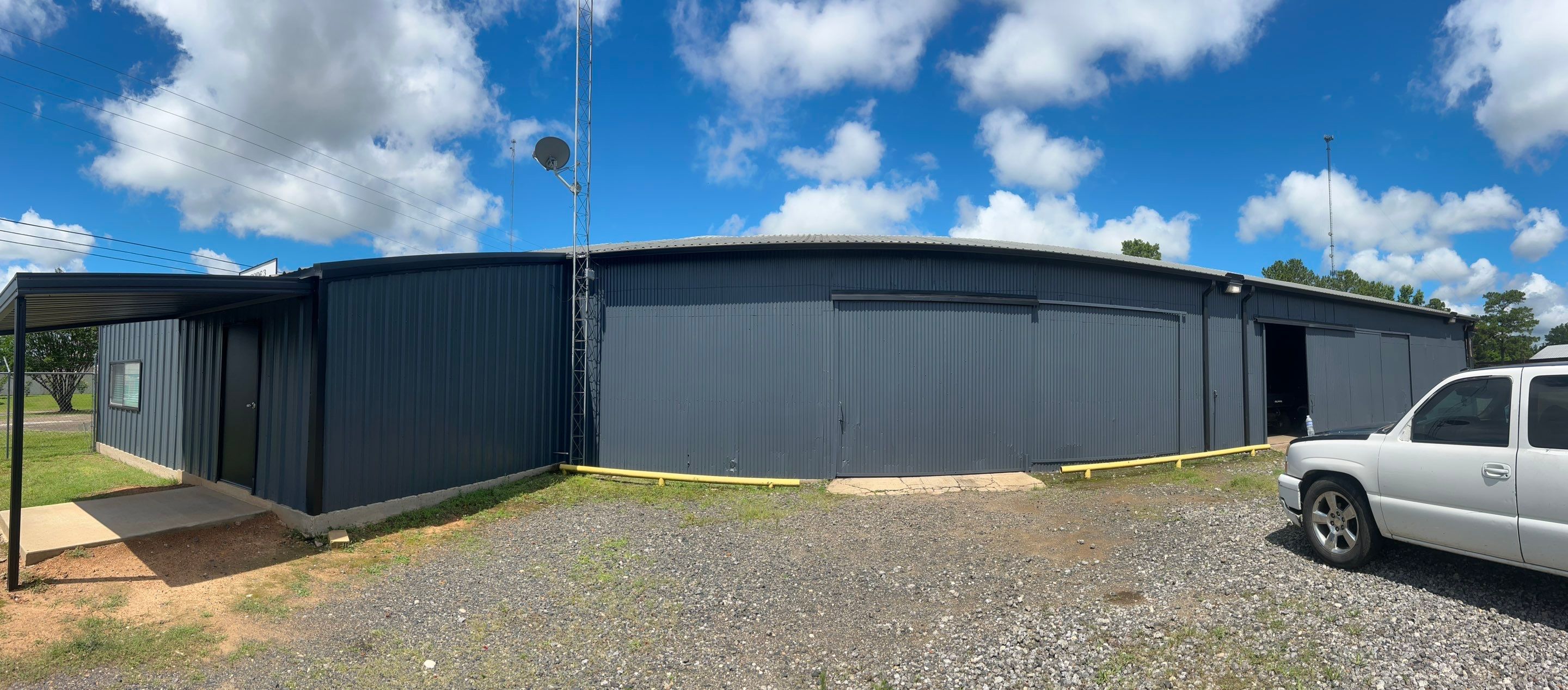 Exterior Painting in Kilgore, TX | Metal Building Transformation from White to Grey by Quality Coats Painting