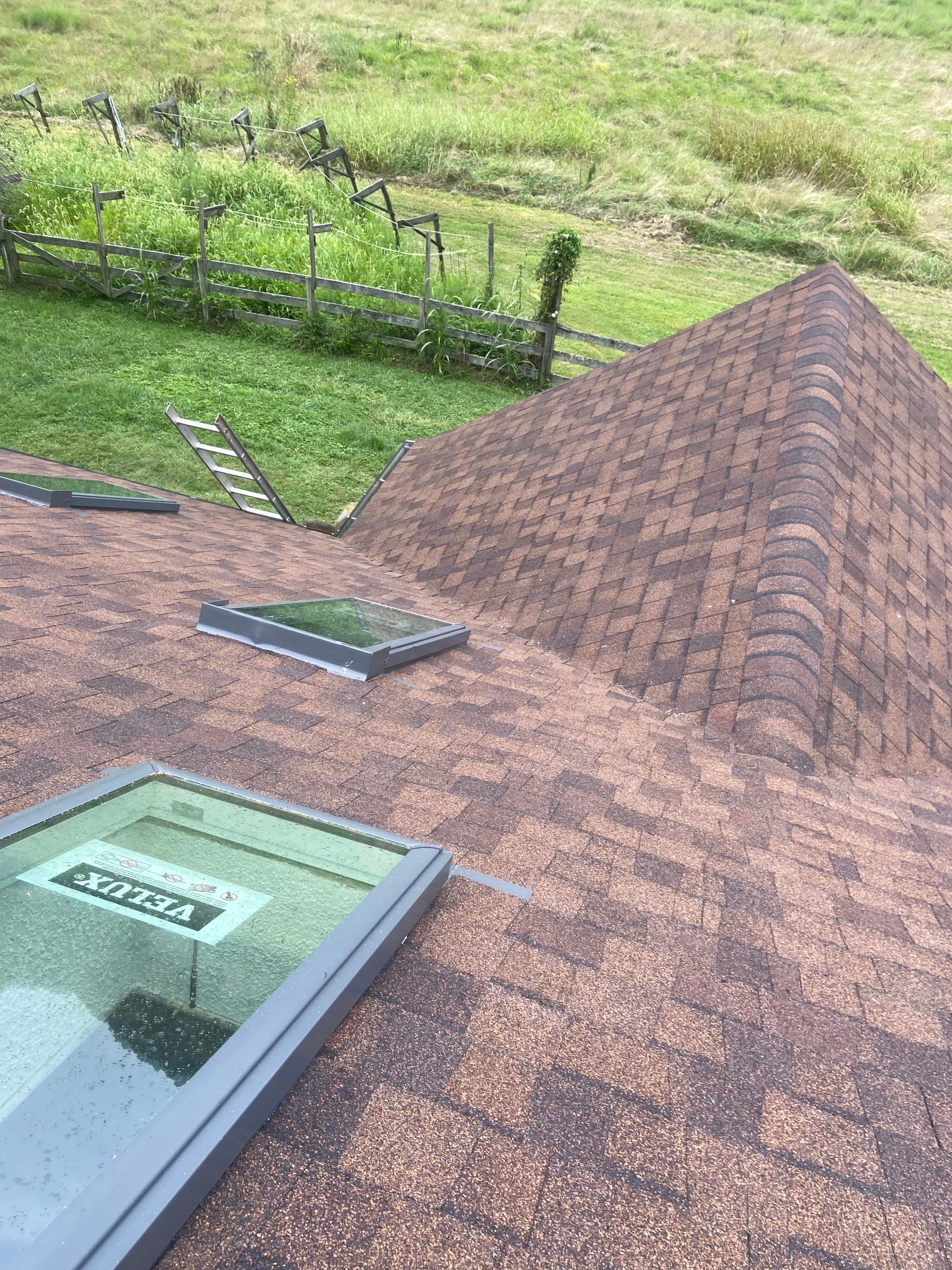 Shingle Roofing with Velux Skylight replacement and stone chimney flashing  by Secure Construction Company Inc