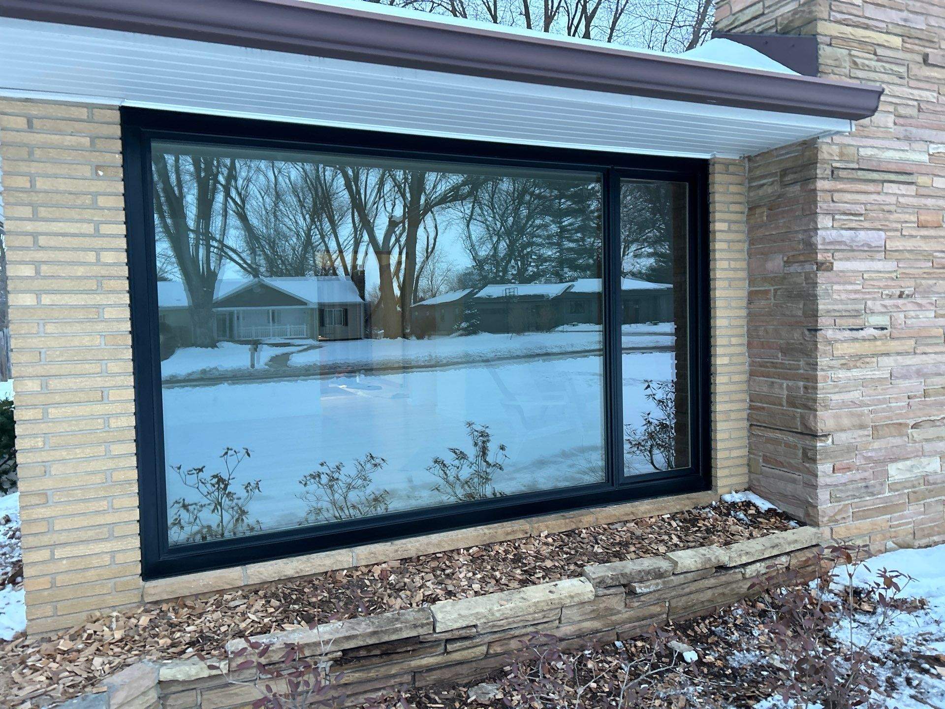 Black-Frame Pella Lifestyle Upgrade on a Partial Brick Home by United Windows and Siding LLC