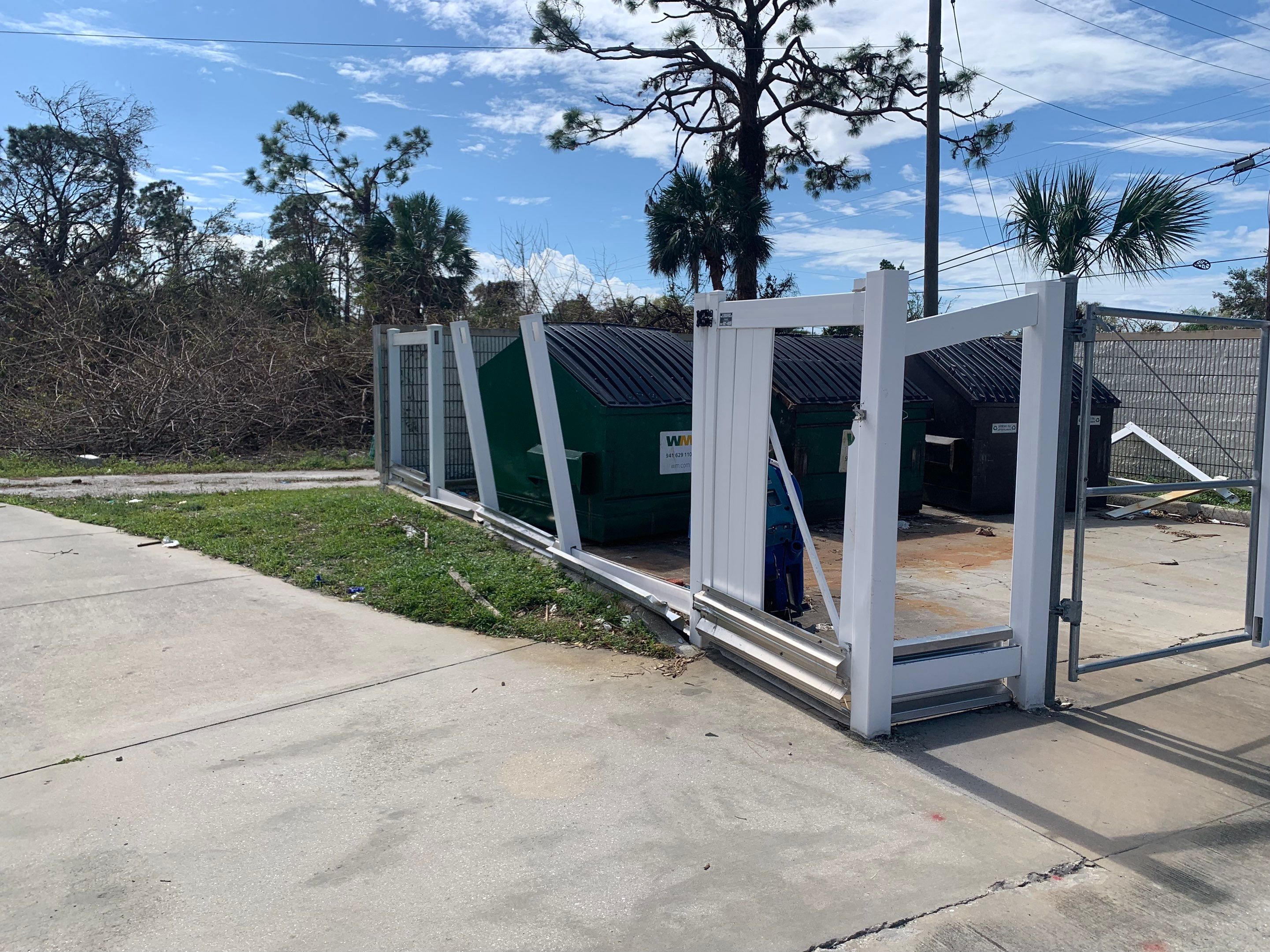 Commercial Chainlink and Vinyl Fence With Aluminum Framed Gates On Dumpster Enclosure by Asap fence and gates, LLC