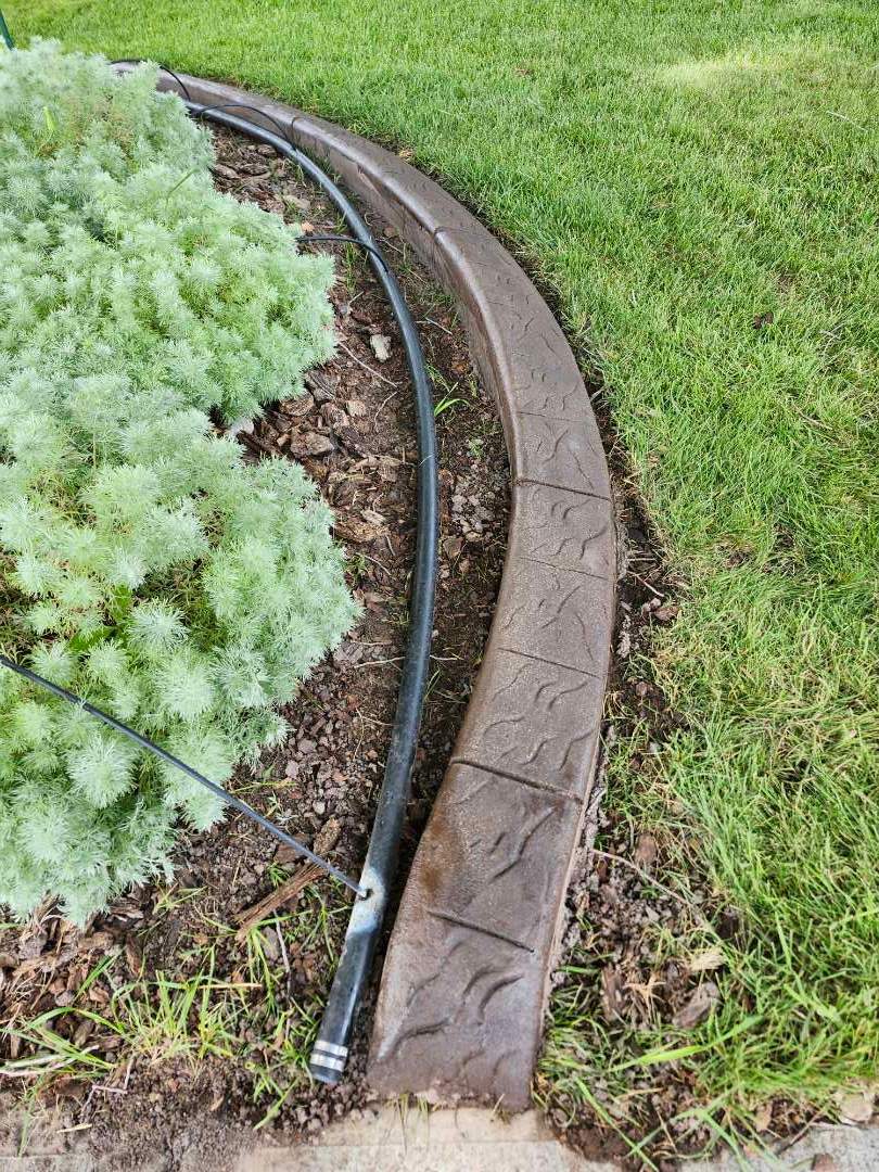 Decorative Stamped Concrete Landscape Edging Installation in Medicine Hat by Pump it Up Concrete Jacking