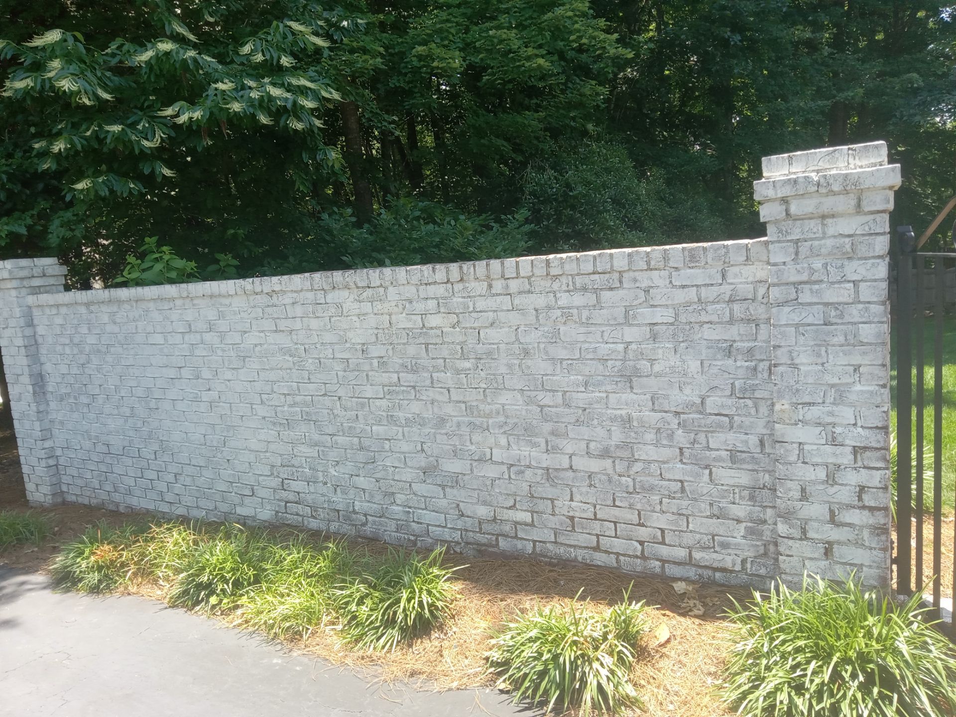 pressure washing brick wall to remove dirt buildup and restore appearance