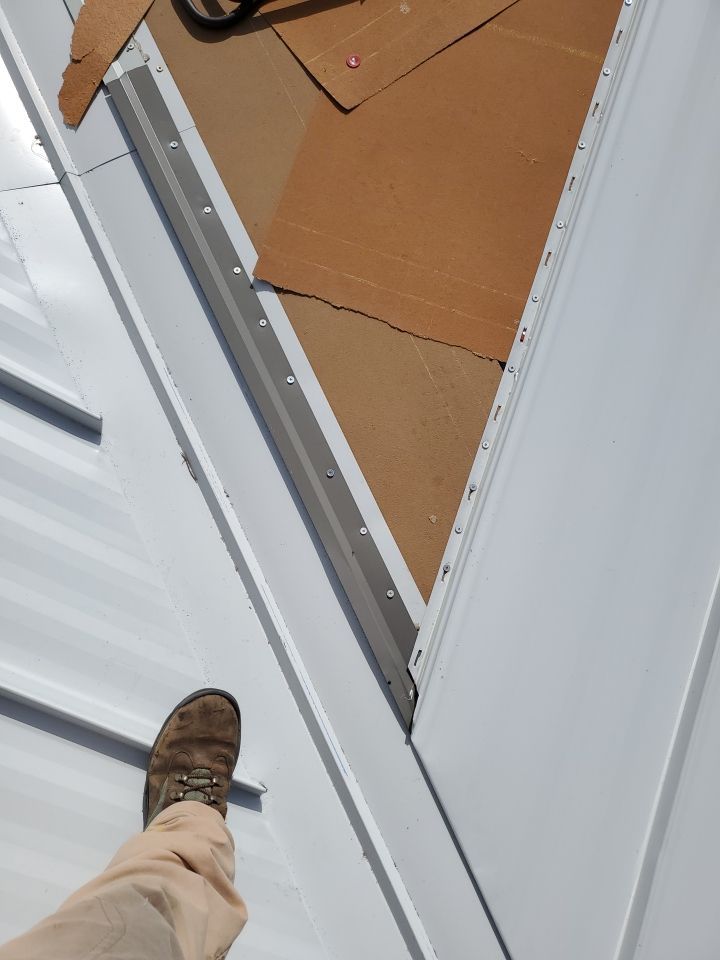 Residential Roofing Installation using 1.5" Nail Strip 24ga Solar White Kynar Coated Standing Seam Metal Panels by Morton Roofing, Inc.