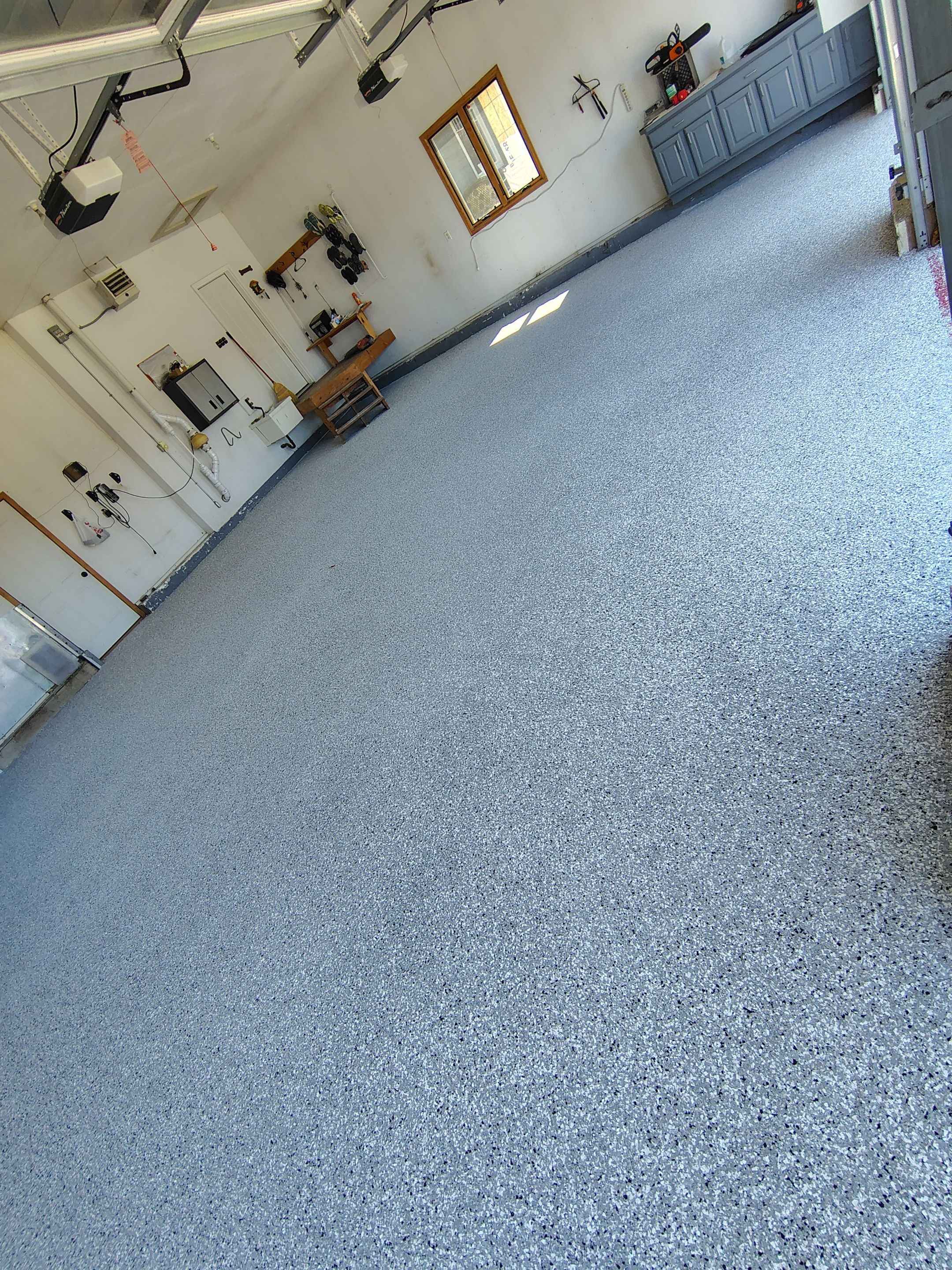 Feather Grey Garage Floor Coating Installation in Valley Springs by Select Painting, Coatings & Garage Cabinets