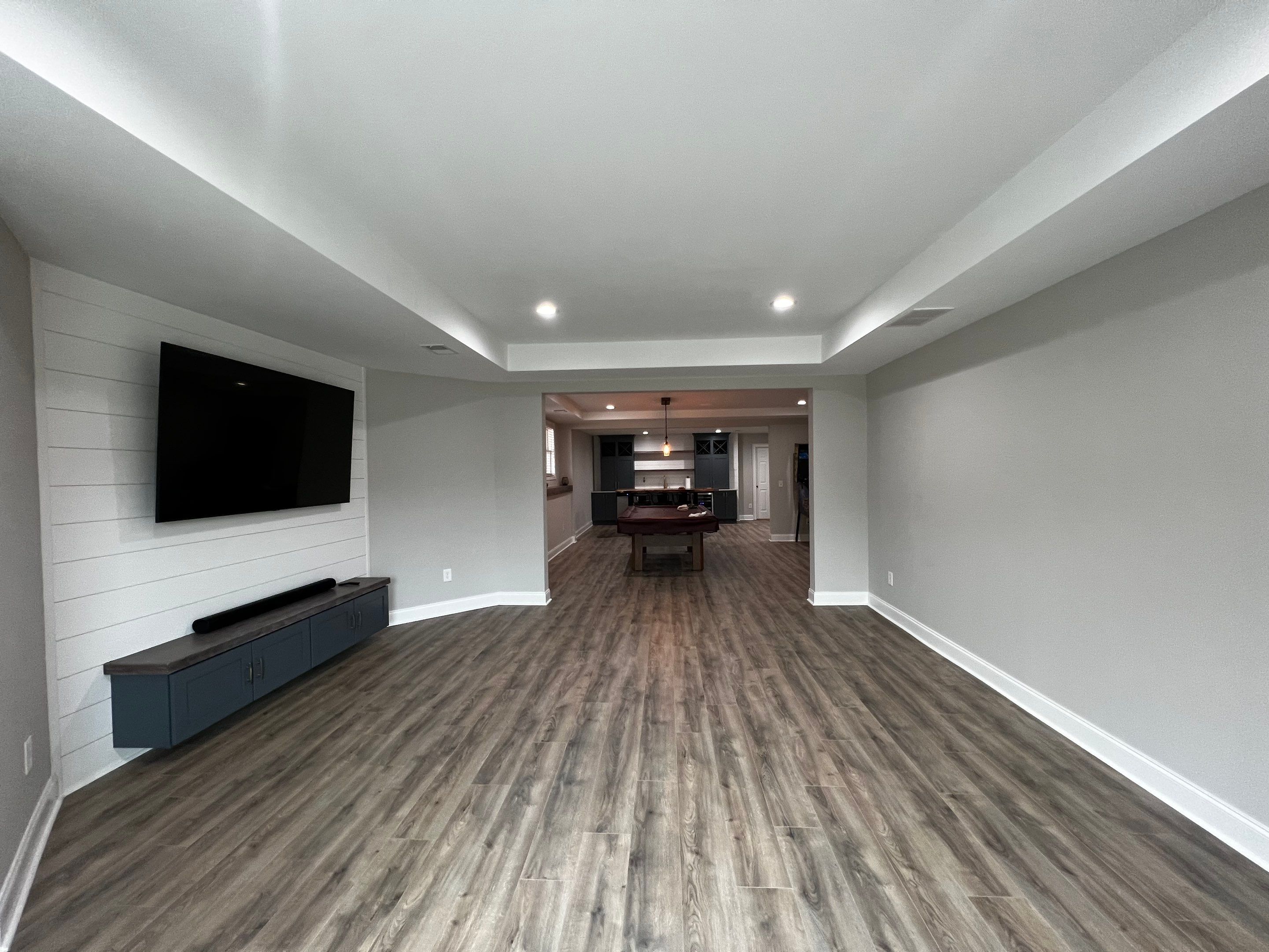 Modern Basement Remodeling in Woodstock with Custom Live-Edge Bar by Swift Home Renovations