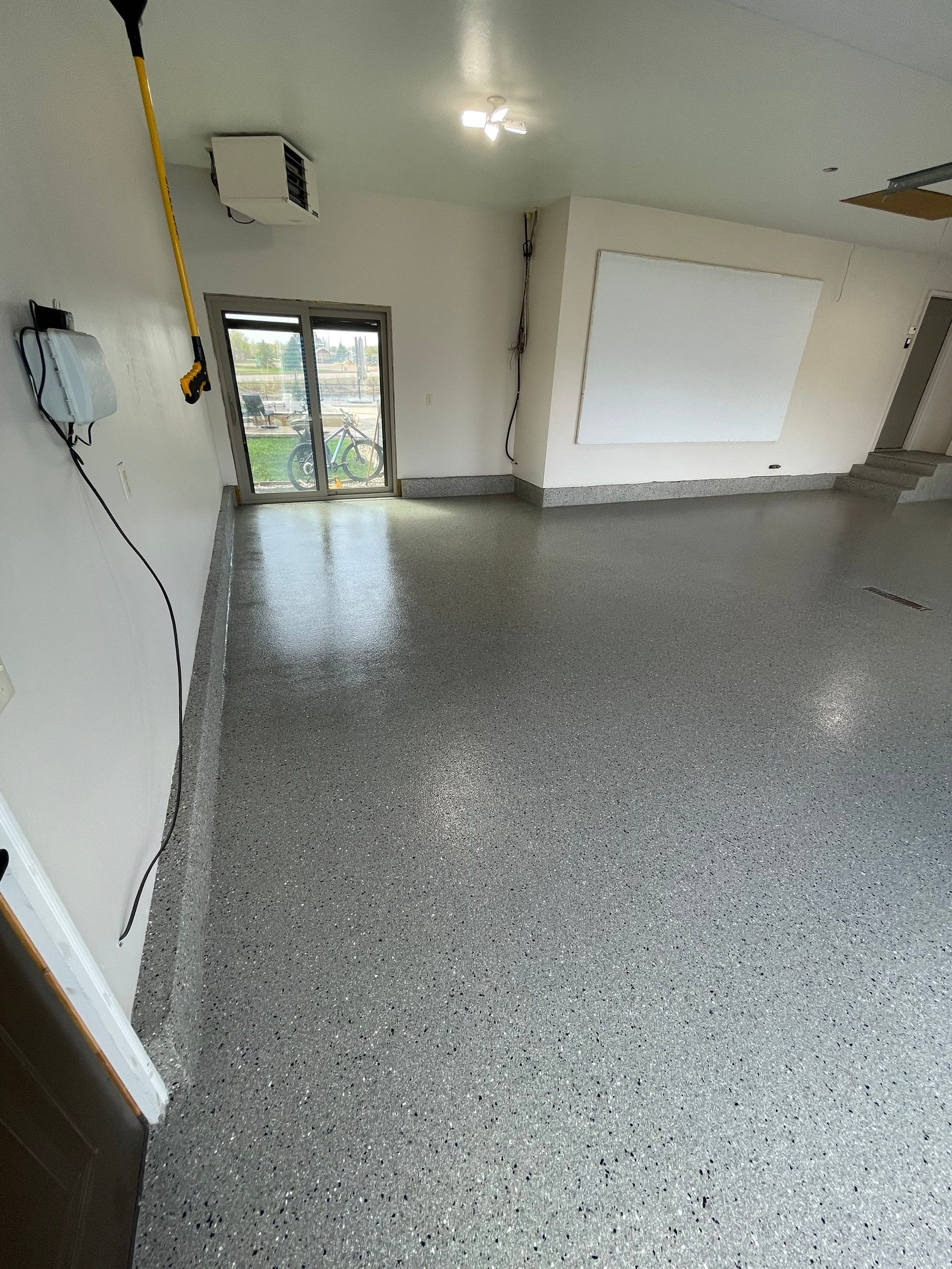 Residential Garage Floor Coating with Grey Speckled Epoxy Finish by Select Painting, Coatings & Garage Cabinets
