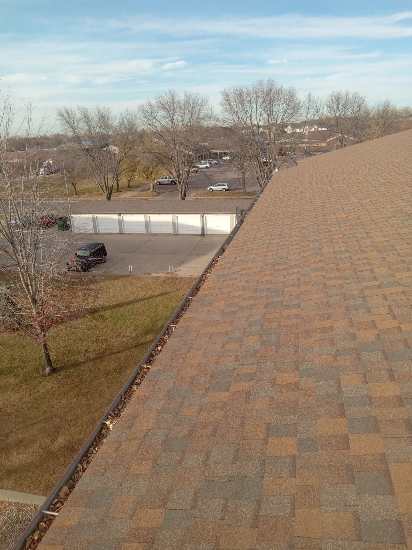Commercial gutter cleaning Sioux Falls, SD before photo with filled gutters