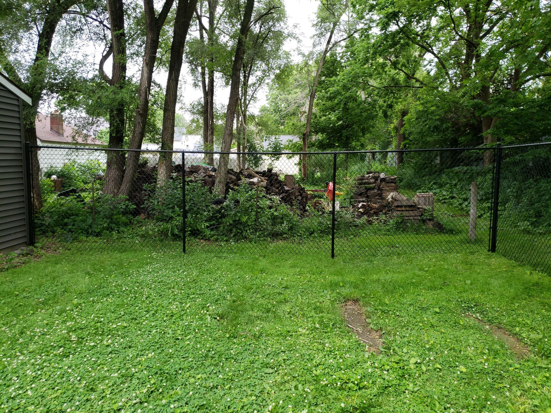 Black Vinyl Chain Link Fence Installation in Charles City by Perfect Picket Fence and Stain