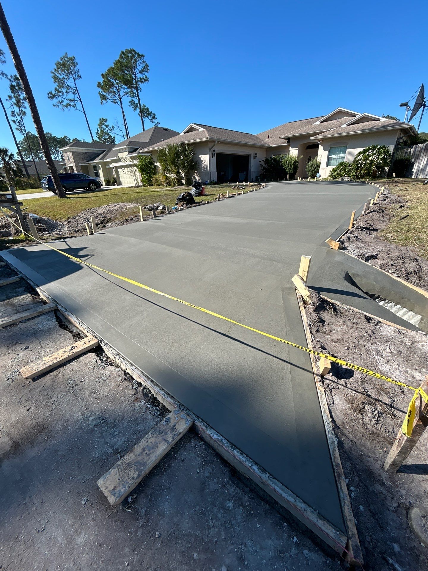 New concrete driveway by Courtesy screening