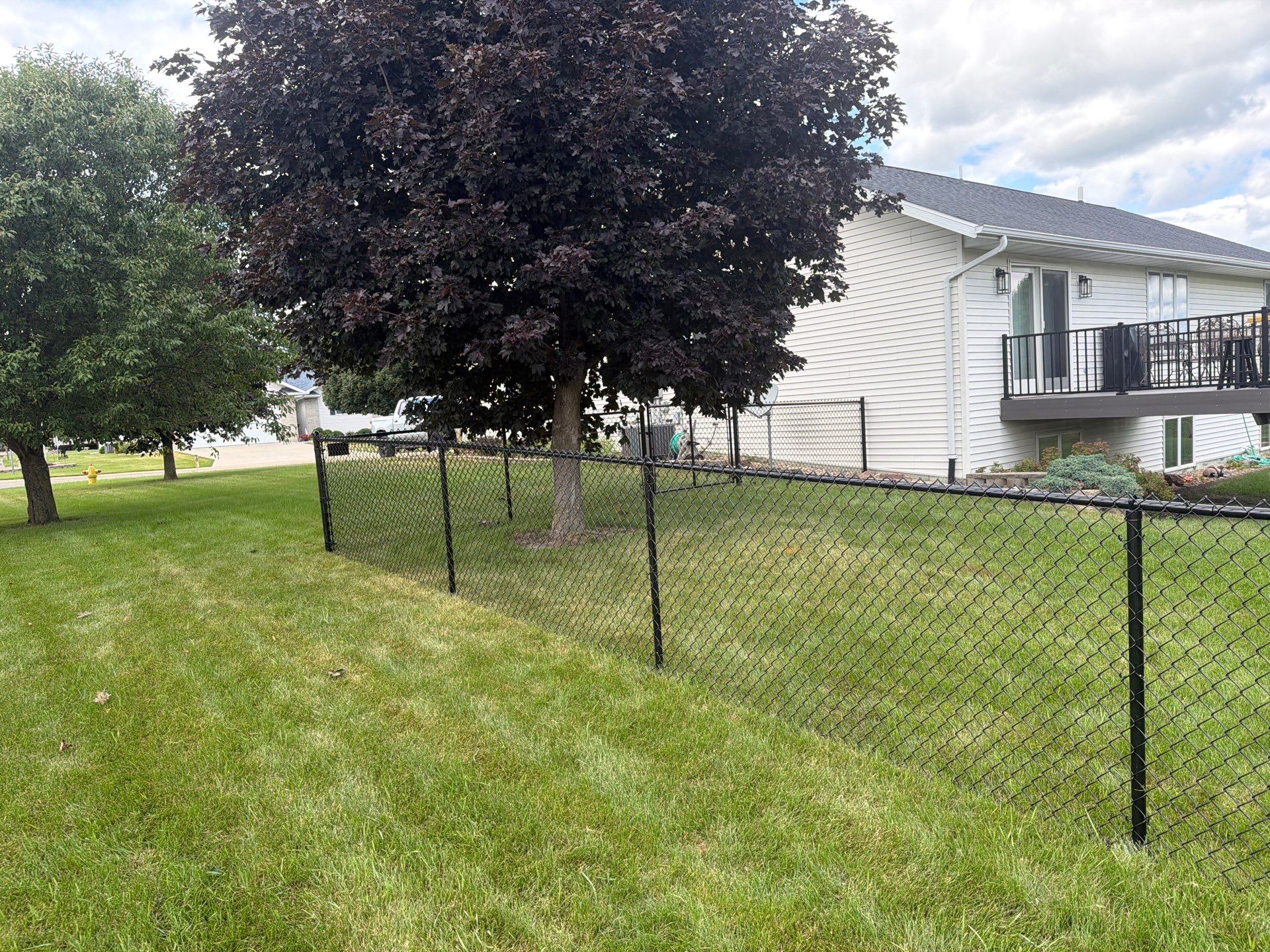 Black Vinyl-Coated Chain Link Fence Installation in Fairbank by Perfect Picket Fence and Stain