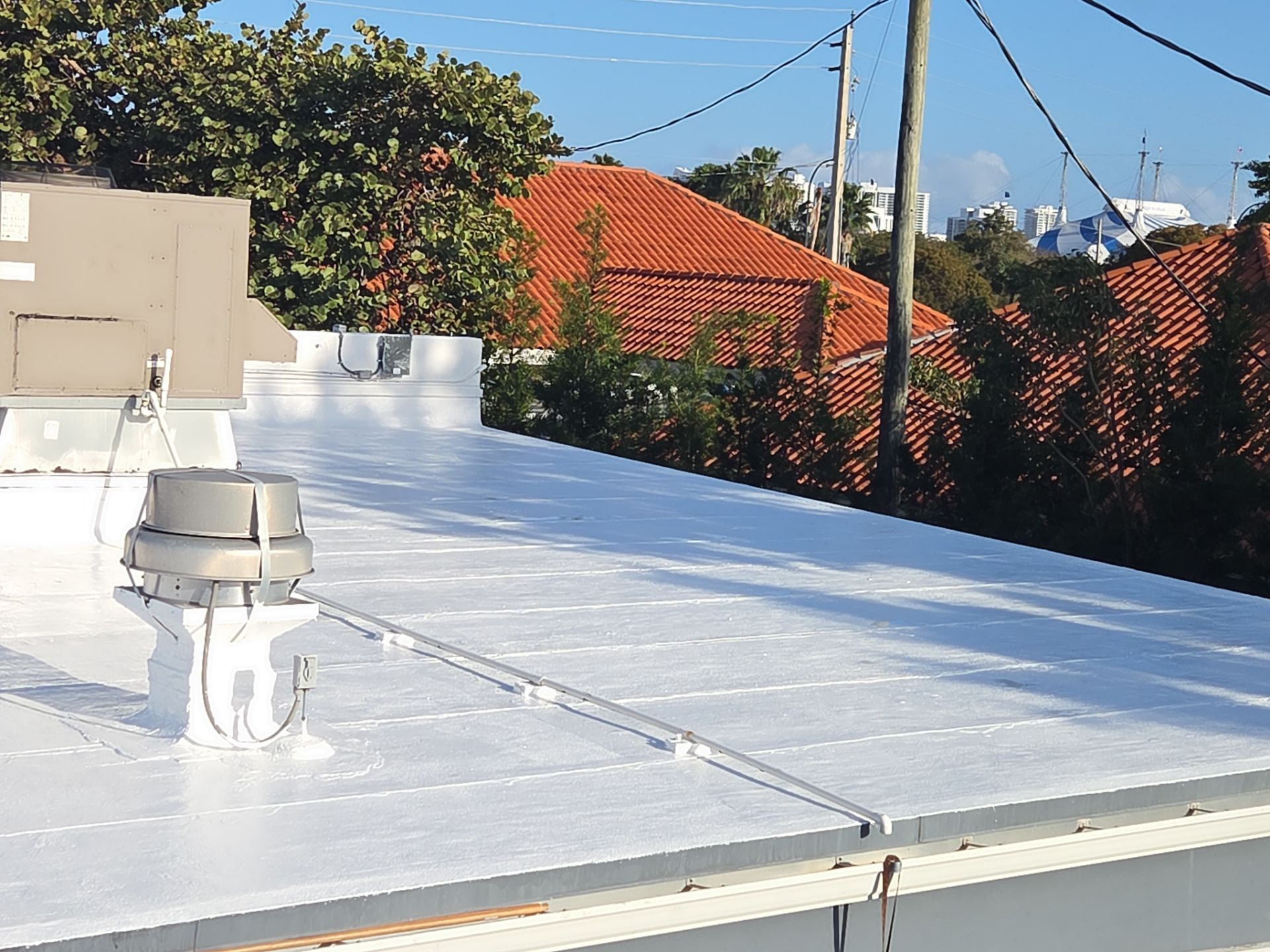 Commercial Flat Roof Restoration Using Silicone Coating in Hallandale Beach by Aastro Roofing