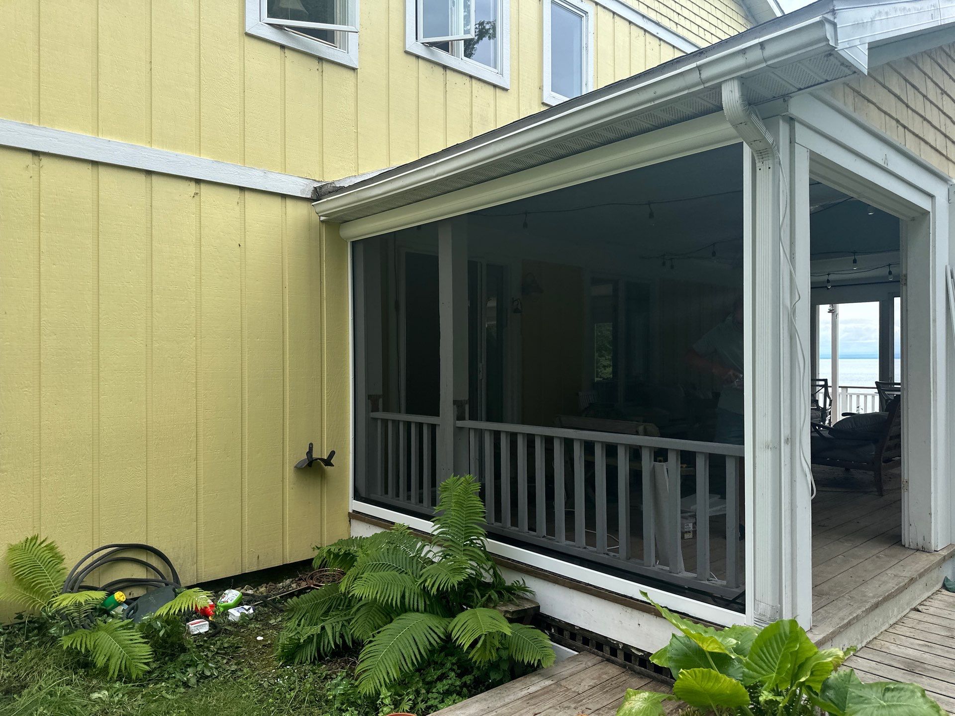 Sunesta motorized Sentry Privacy Screen Installation for Saint Ignace Waterfront Porch by Rainbow Seamless Systems