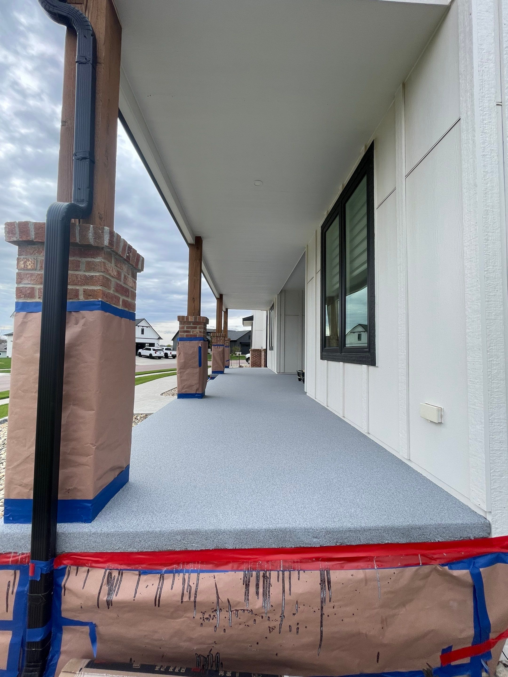 Grey Speckled Concrete Porch Coating for Sioux Falls Home by Select Painting, Coatings & Garage Cabinets