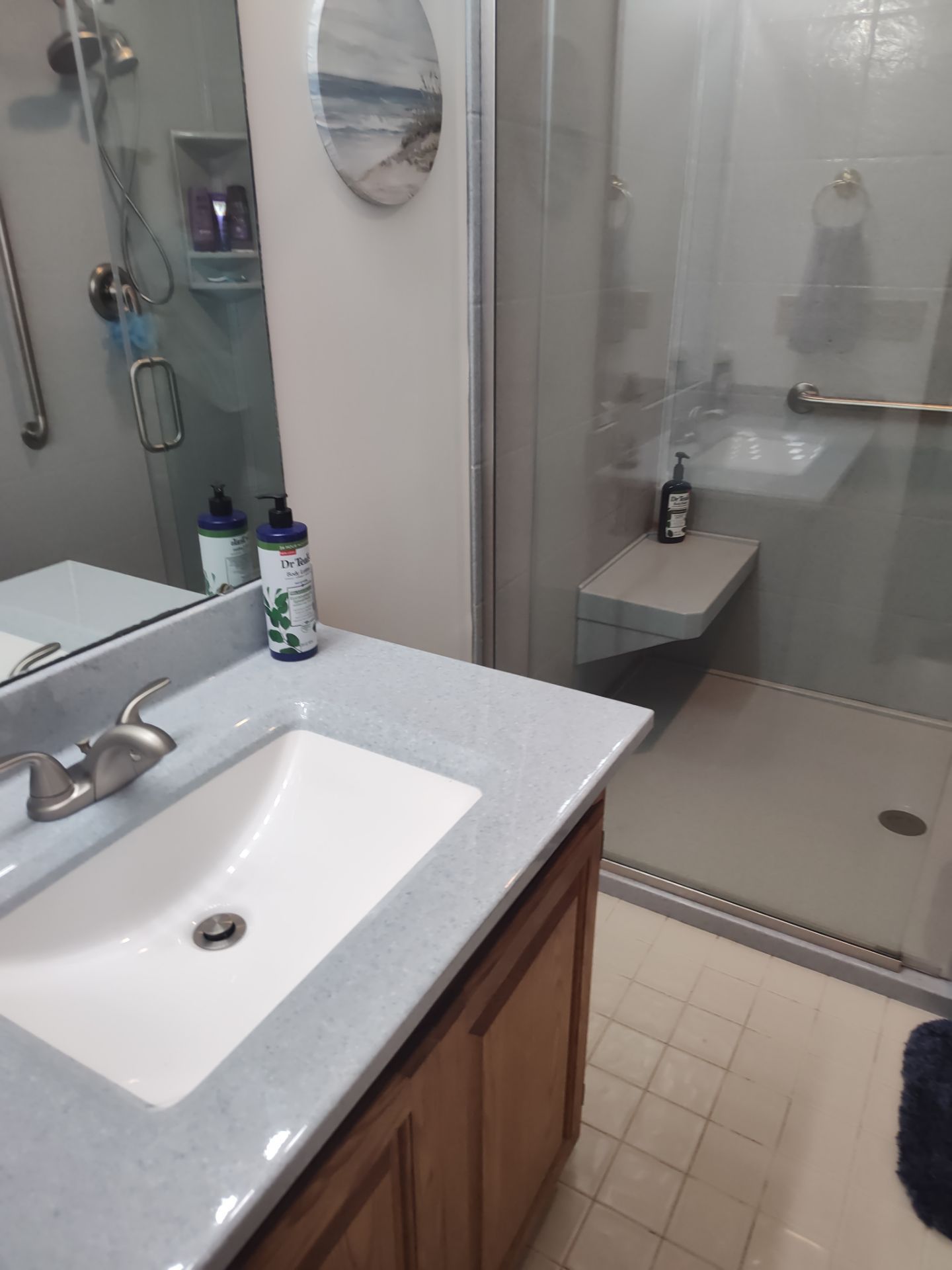 Bathroom Remodel using Onyx base and shower walls with seat & caddie by Cornerstone Home Builders, LLC