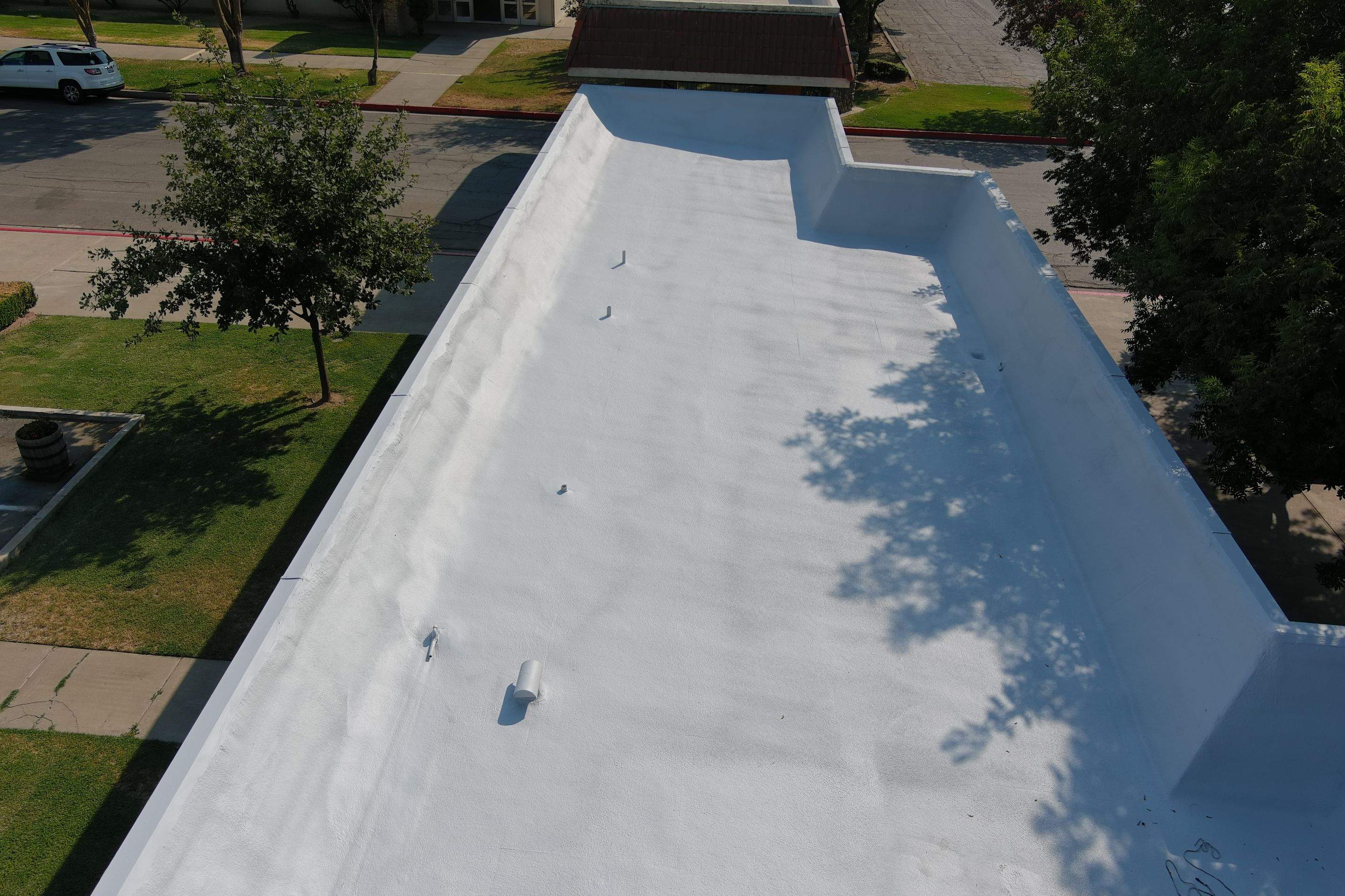 Commercial Roofing Installation using General Coatings acrylic coatings and spray foam by Straight Edge Roofing Inc
