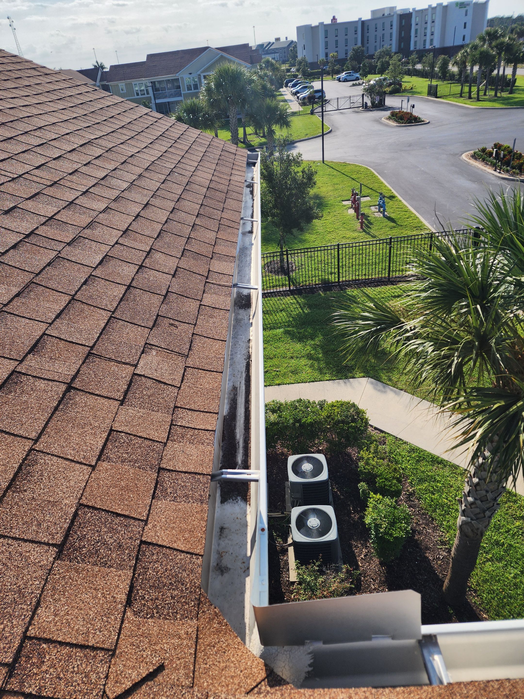 HOA gutter cleaning in Port Charlotte, FL, after  photo showing full gutters.