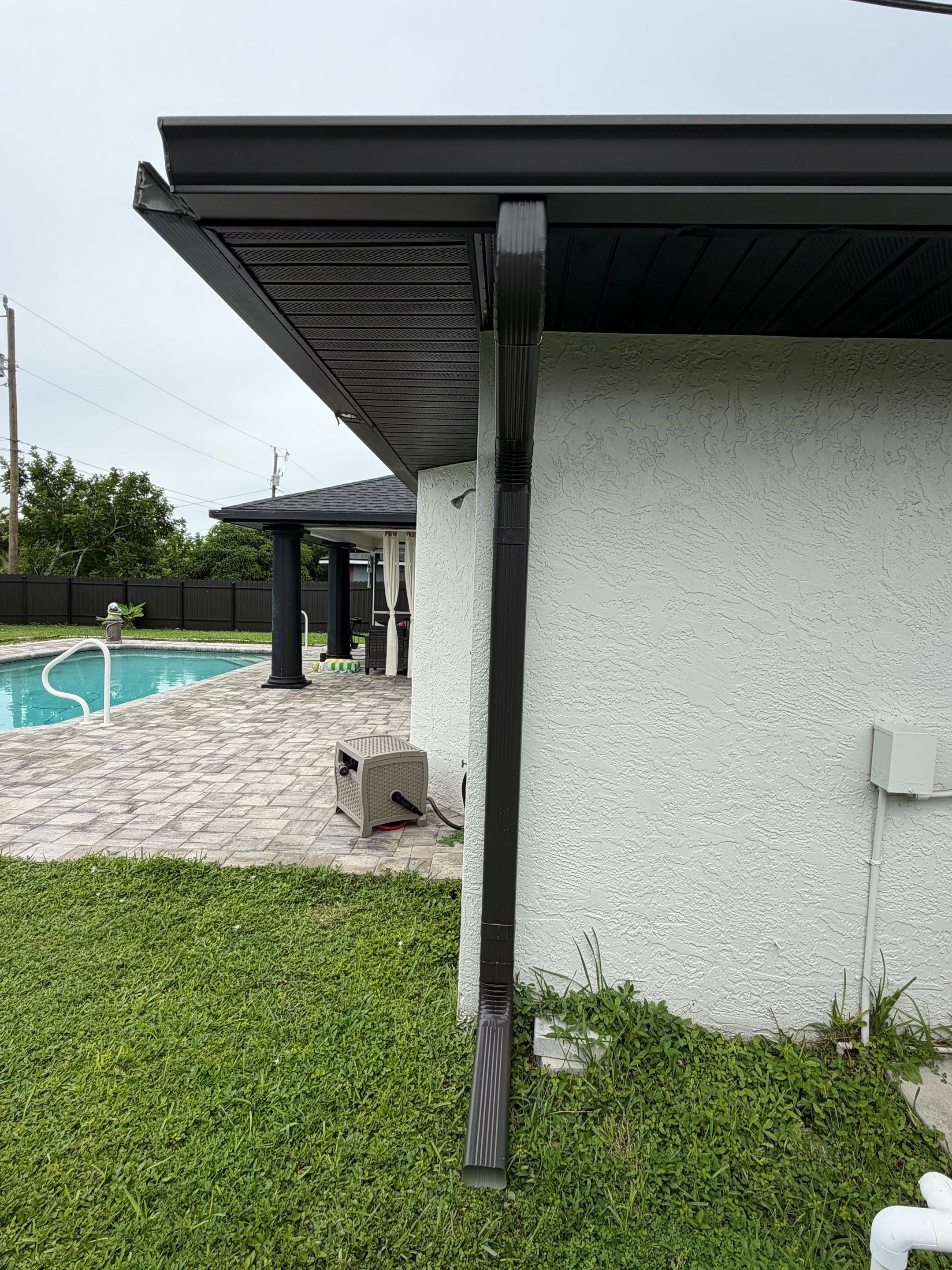 Black Seamless Gutters for a Modern Look in Cape Coral FL by Gutter Professors