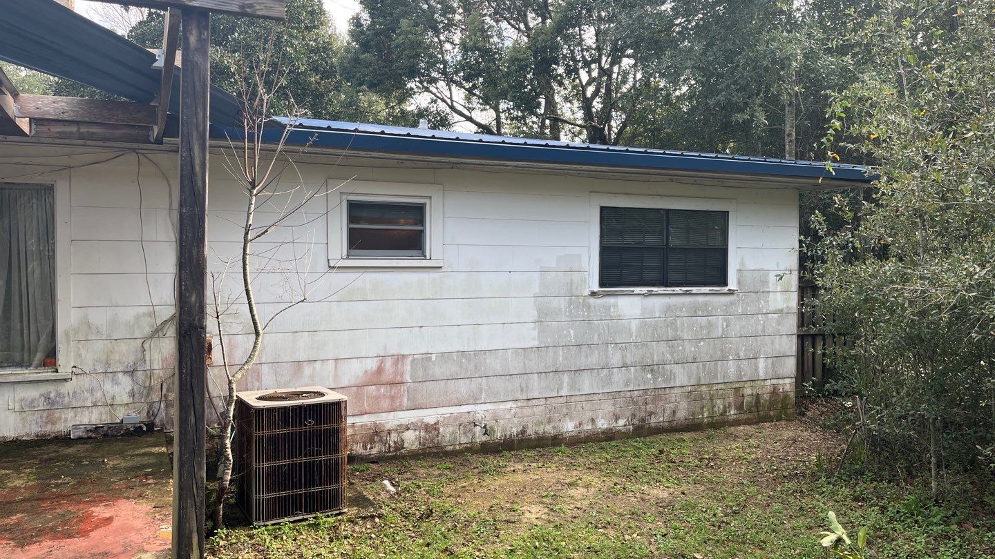 White Seamless Gutters and Black Downspouts by Gutter Professors