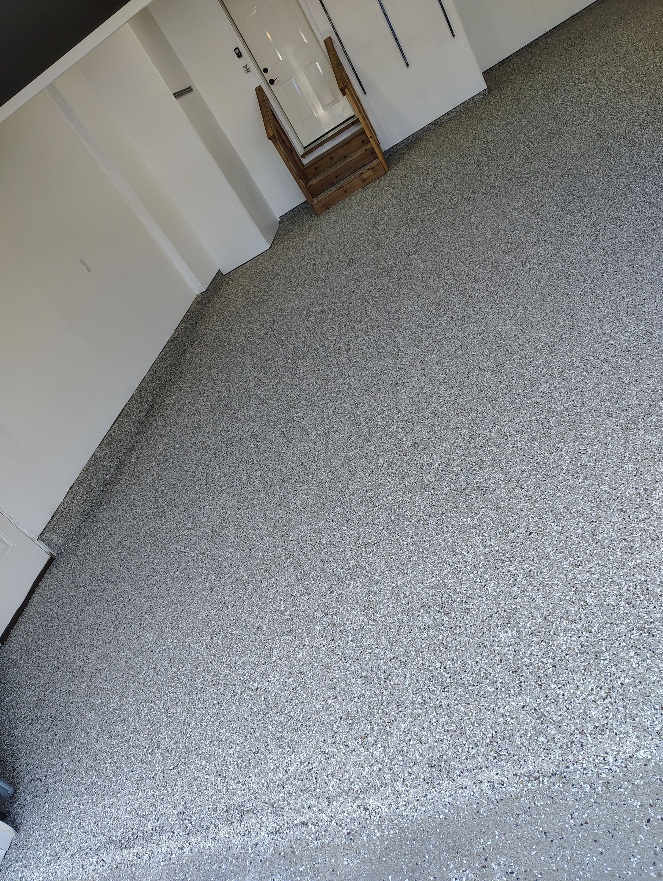 Sioux Falls Garage Floor Transformation With Gray Speckled Epoxy Coating by Select Painting, Coatings & Garage Cabinets