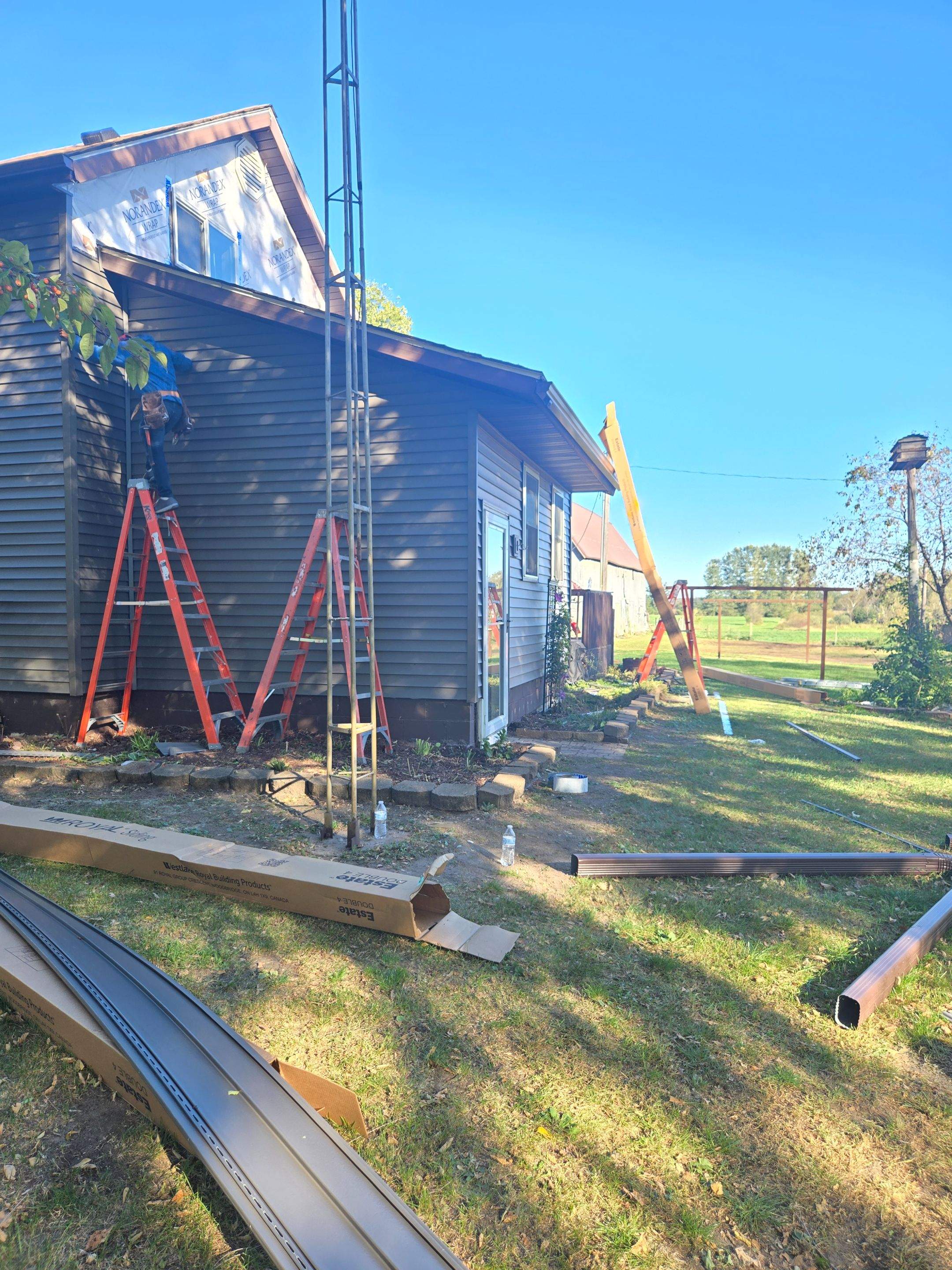 Royal Granite Siding Replacement & Brown Seamless Gutters by Next Level Seamless Gutters / Exteriors Inc.