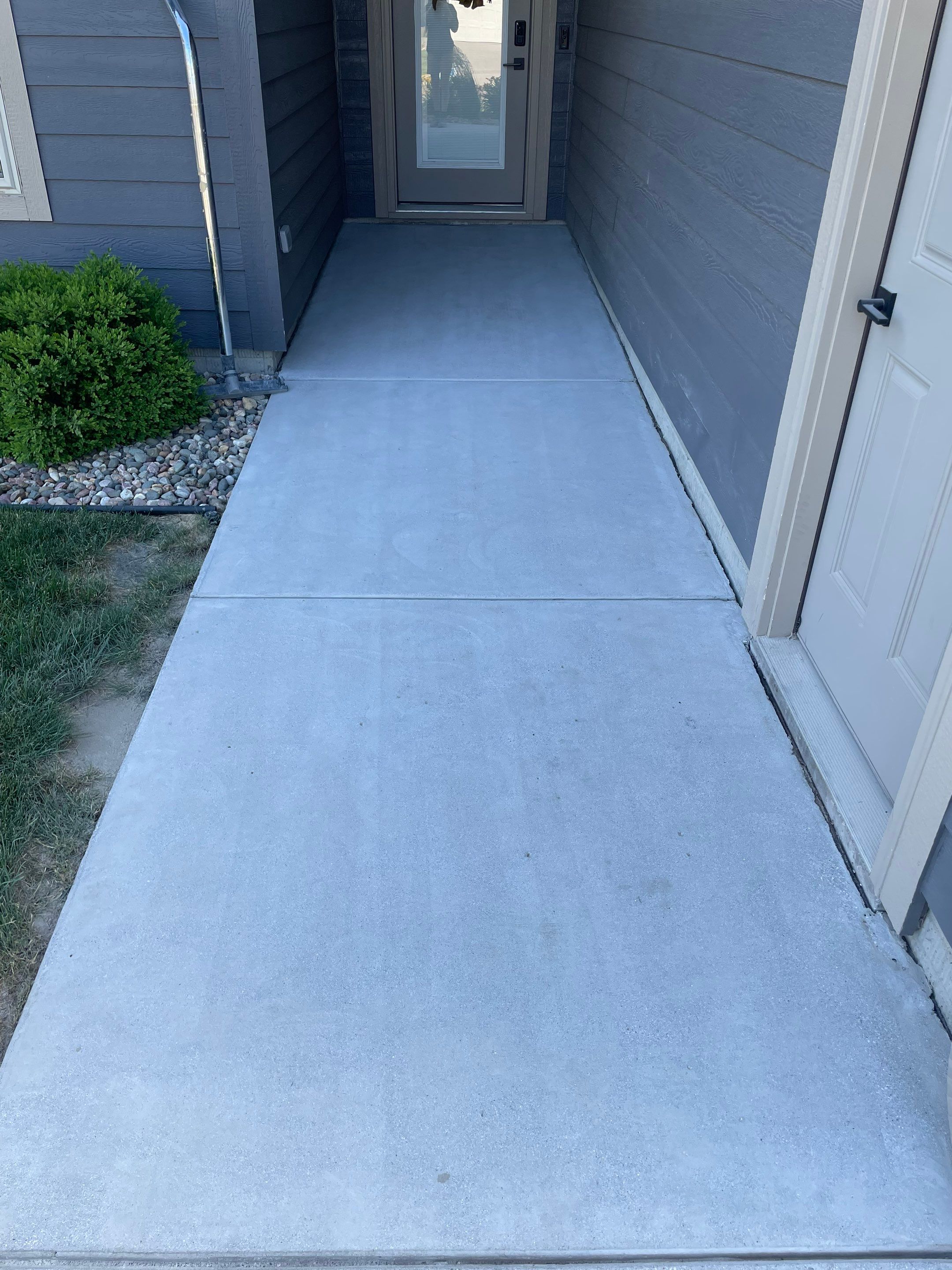 Textured Concrete Patio Coating and Custom Privacy Pergola in Sioux Falls by Select Painting, Coatings & Garage Cabinets