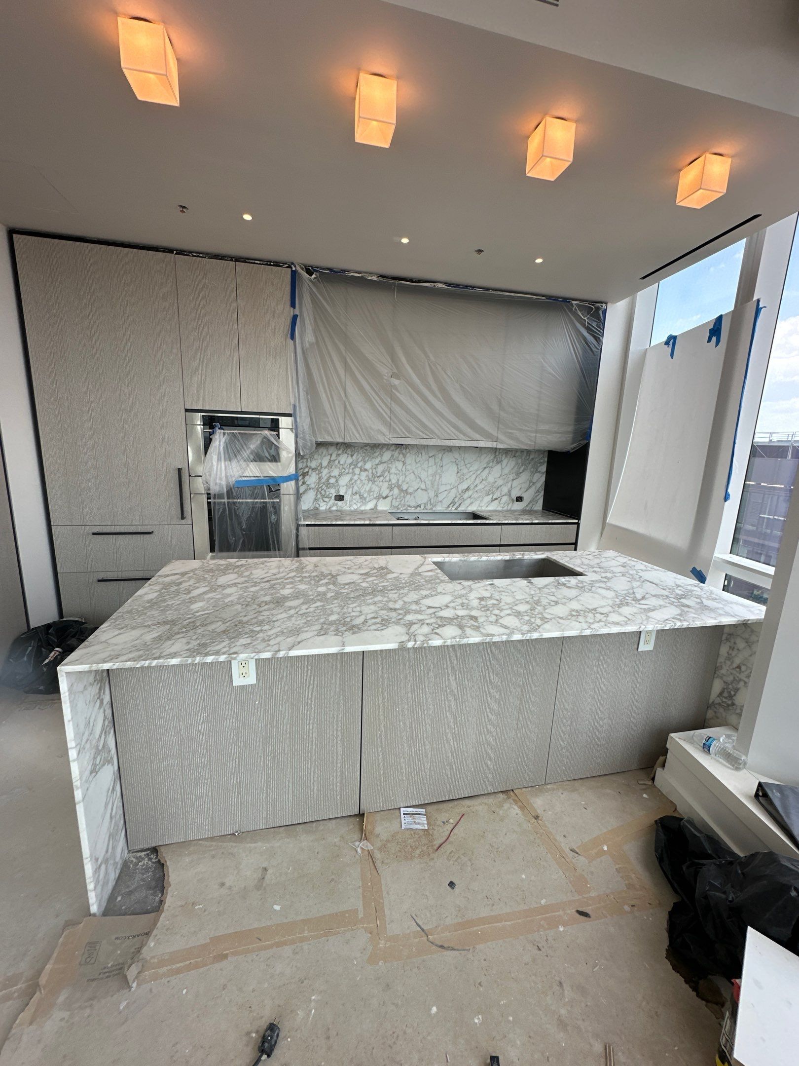 Kitchen Countertop with backsplash and Island top with mitered waterfalls by NC Stone And Tiles