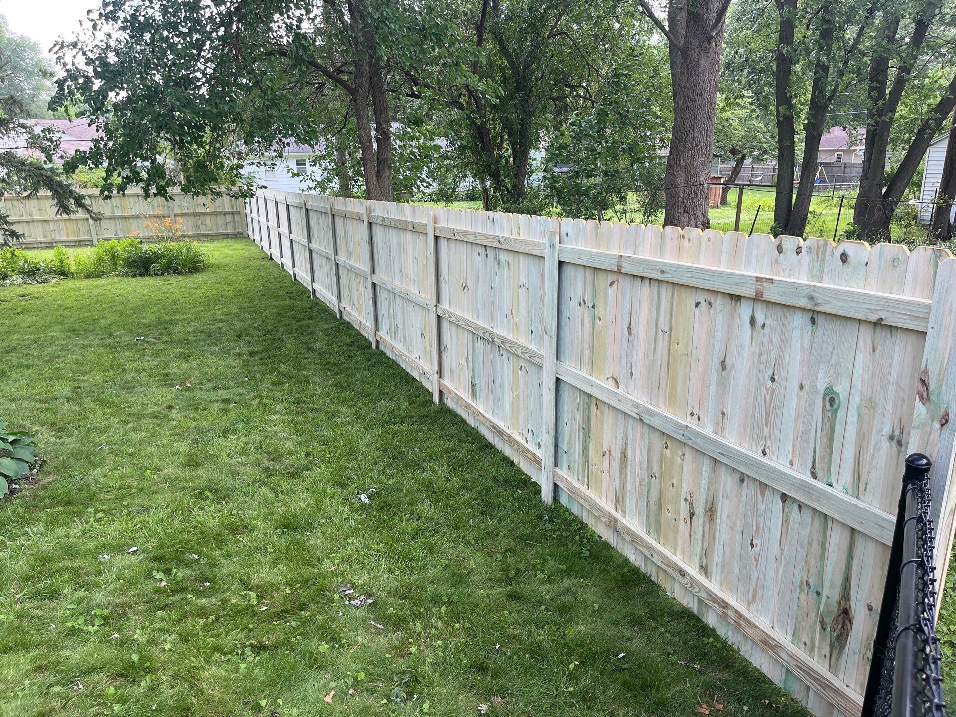 Custom Treated Pine Privacy Fence and Chain Link Installation in Cedar Falls by Perfect Picket Fence and Stain