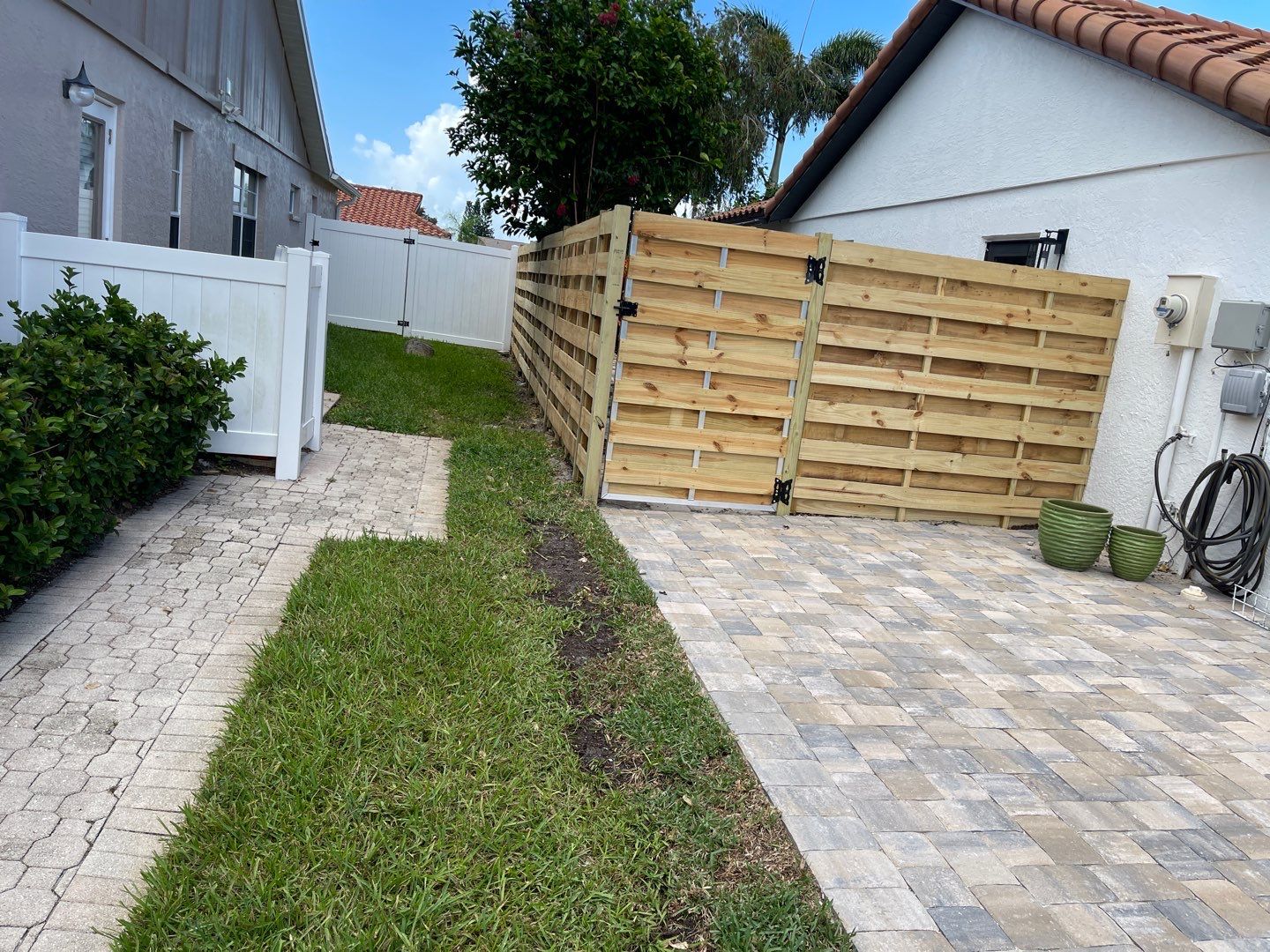 Sarasota, FL 6ft. Tall Horizontal Shadowbox Wood with 4ft. Tall 3-Rail Black Aluminum Fence by Asap fence and gates, LLC