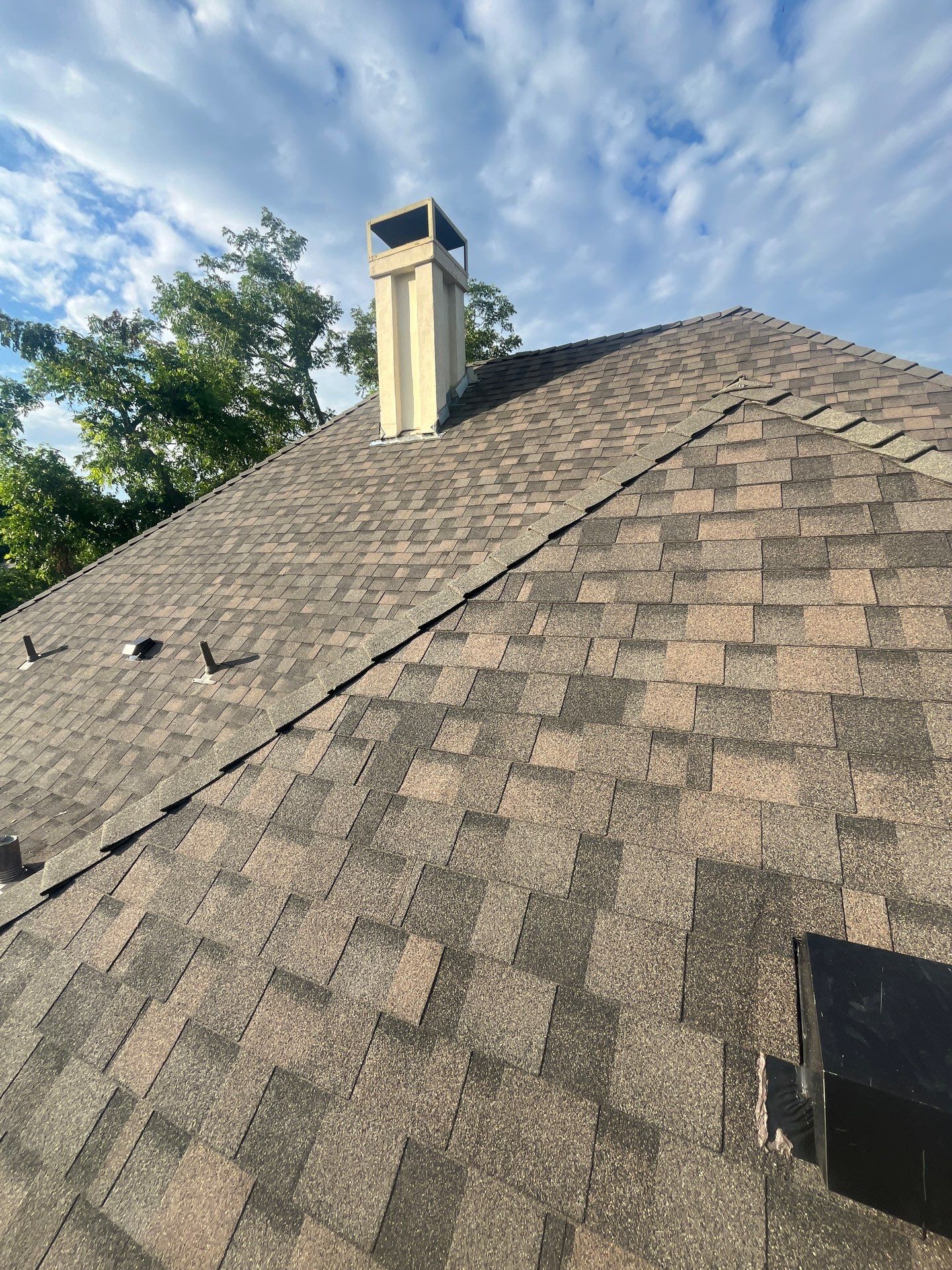 Tan exterior with IKO Driftshake by Tejas Roofworks + Restoration