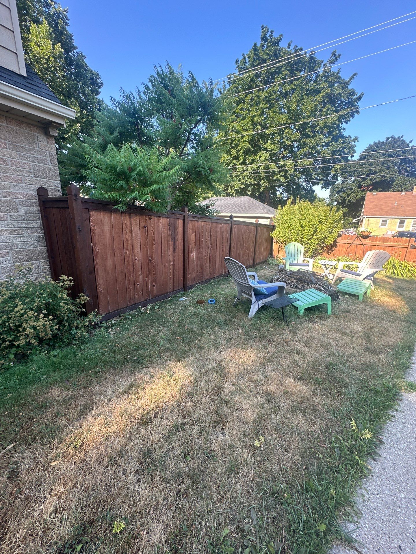 Dark Stained Privacy Fence and Composite Deck in Milwaukee by OCS Contracting Services