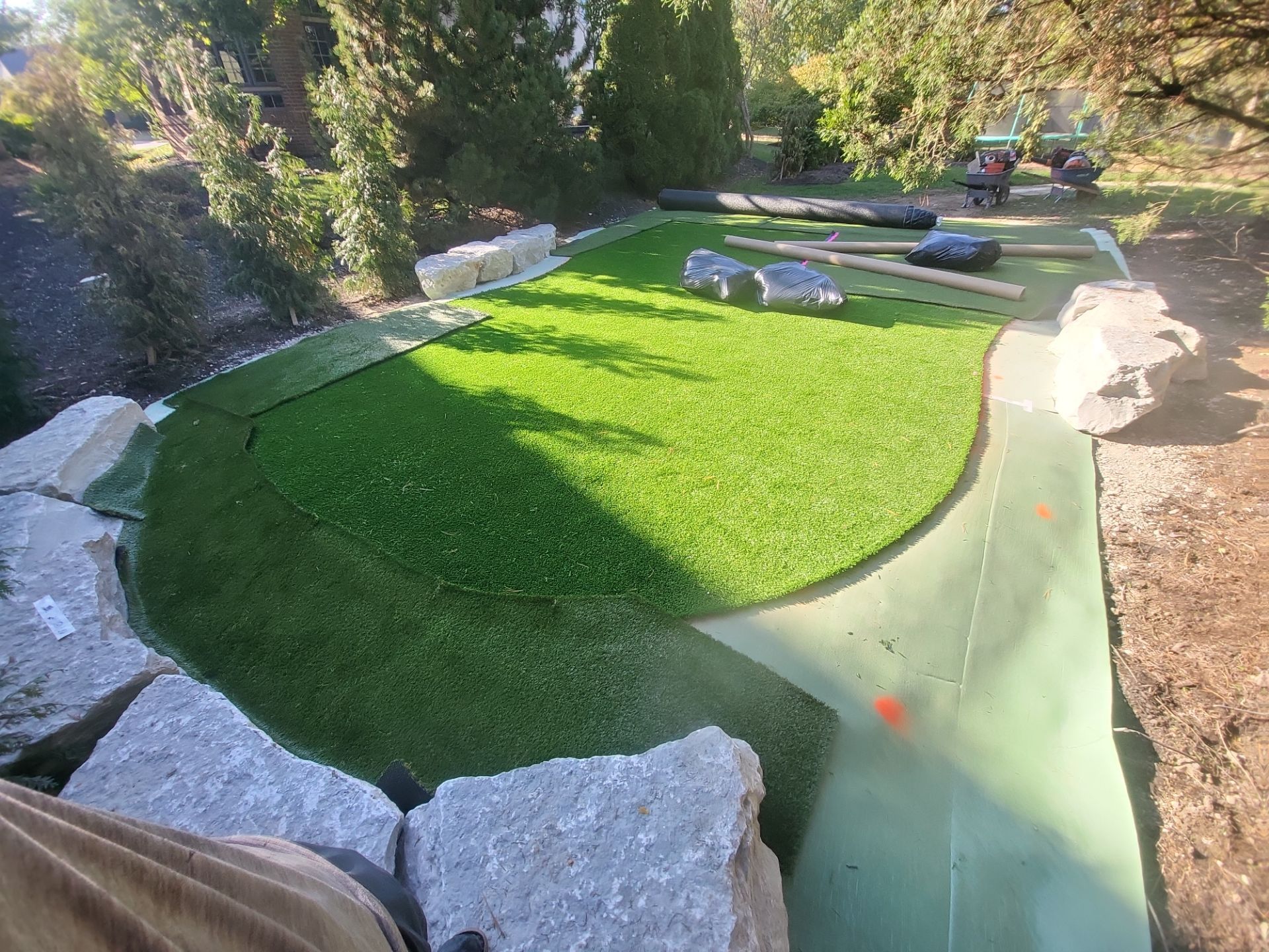 Custom Backyard Putting Green around Landscape Boulders in Hilliard by Southwest Greens Midwest