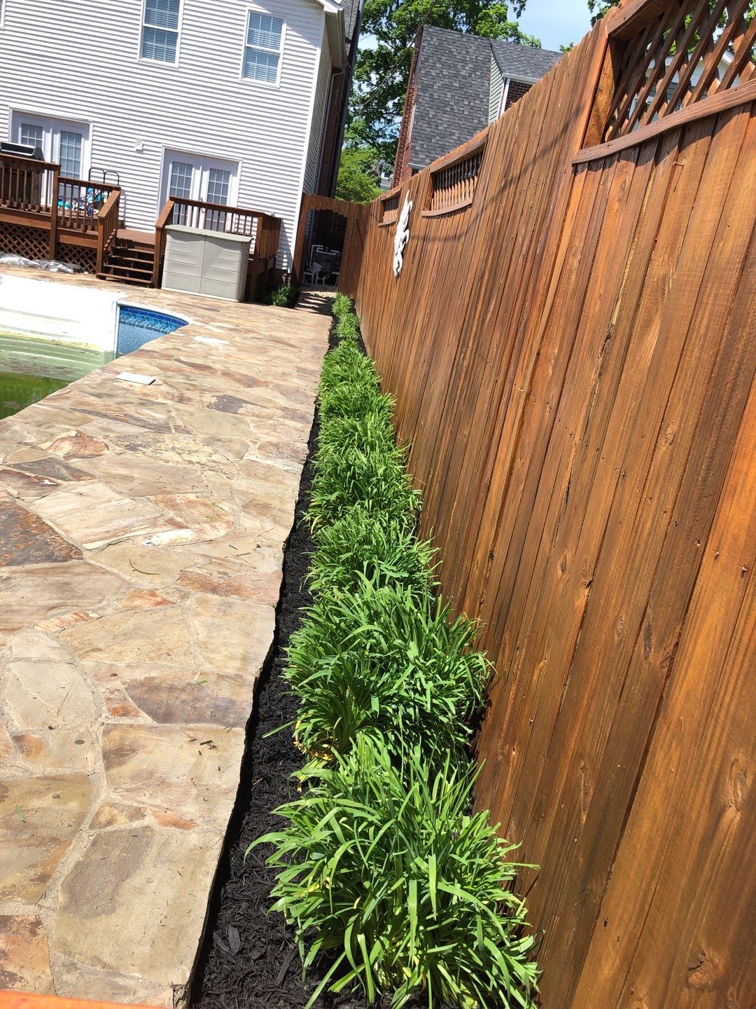 Liriope grasses, mulch and stone pavers by GrassBusters, Inc.