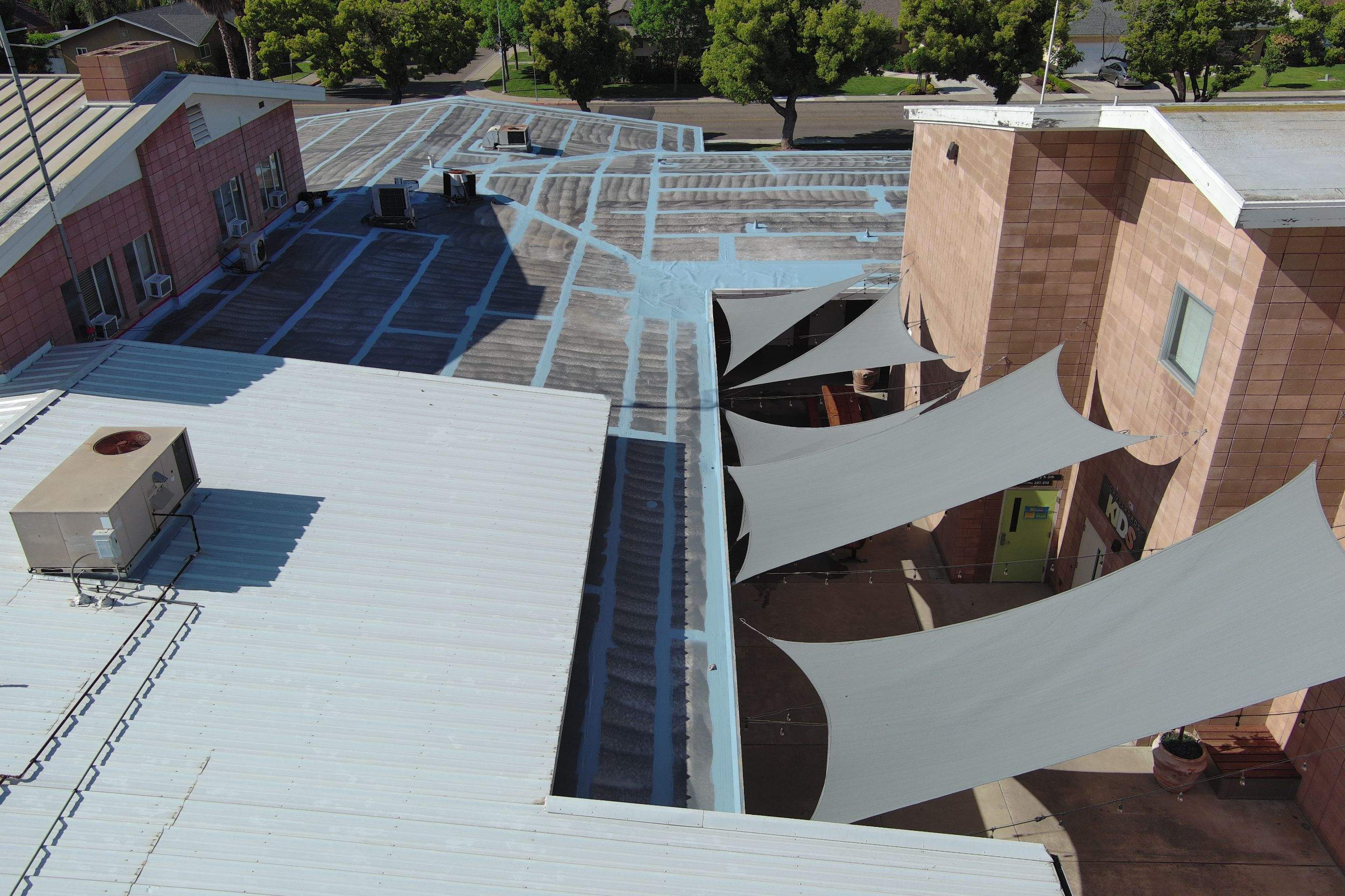 Single-ply restoration system using Benchmark/PUMA XL coatings over TPO single-ply roofing by Straight Edge Roofing Inc