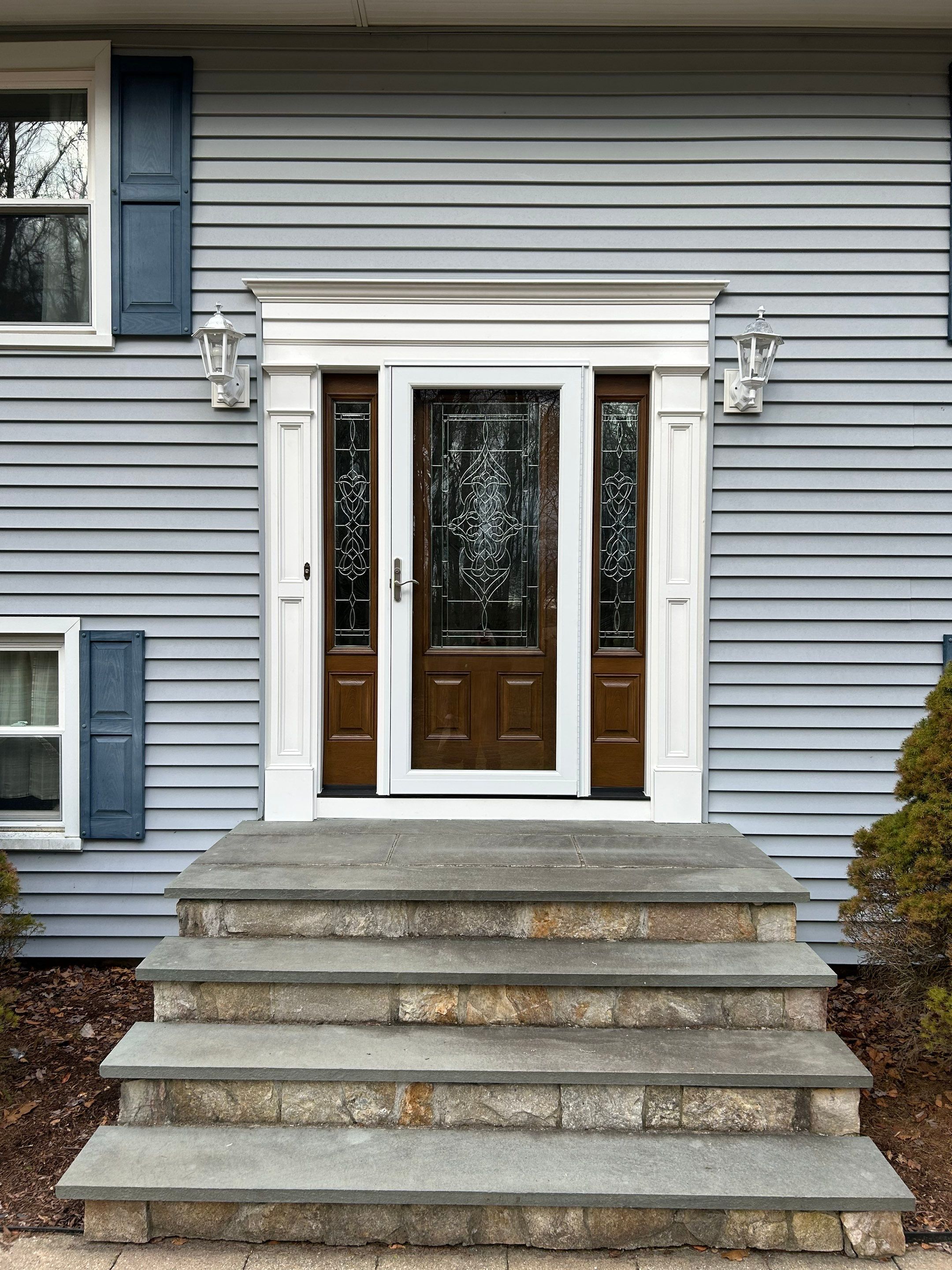 Front Entry Transformation with Decorative Glass Doors by DiGiorgi Roofing and Siding Inc