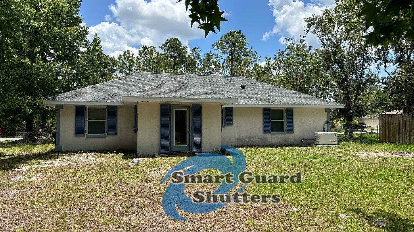 Impact Rated Colonial Shutters in Pigeon Blue by Smart Guard Shutters