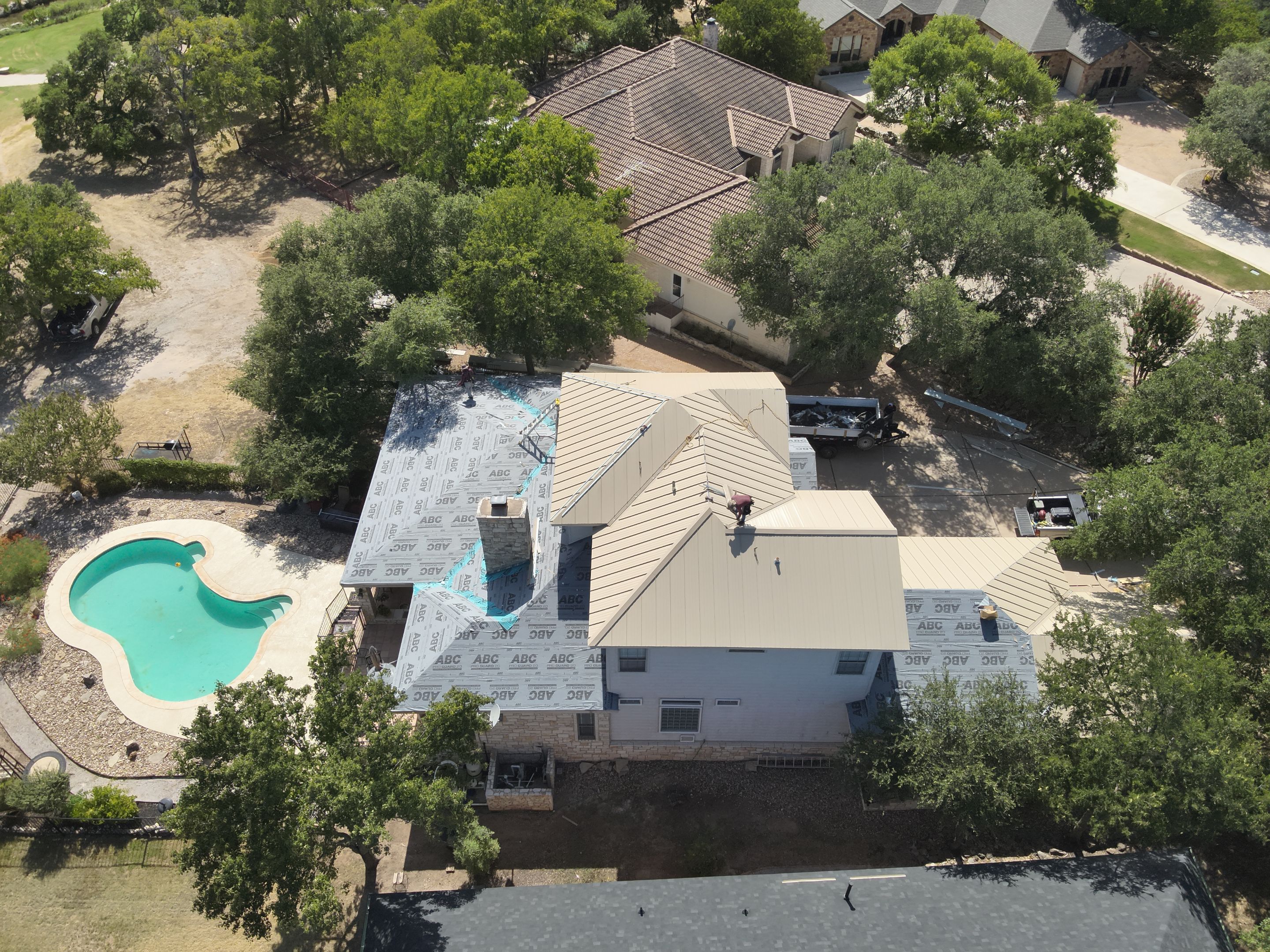 Residential Roof Replacement using 24 GA Double-Lock - Surrey Beige by Action Exteriors Austin