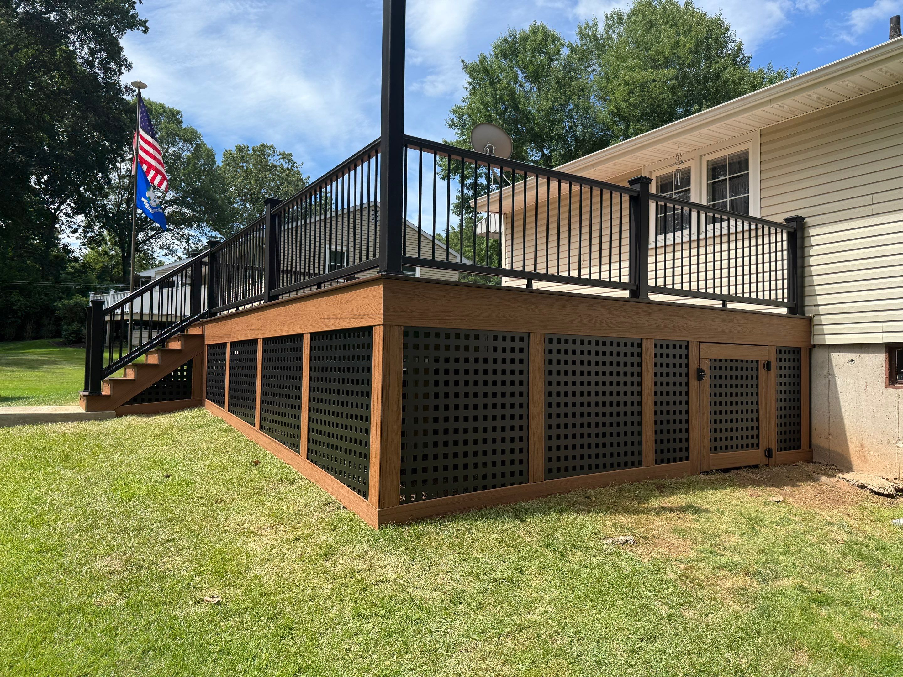 Replacement Deck, Trex Tropical Tiki torch , Matching Fascia. Black Transcend railing and Lattice. by DiGiorgi Roofing and Siding Inc