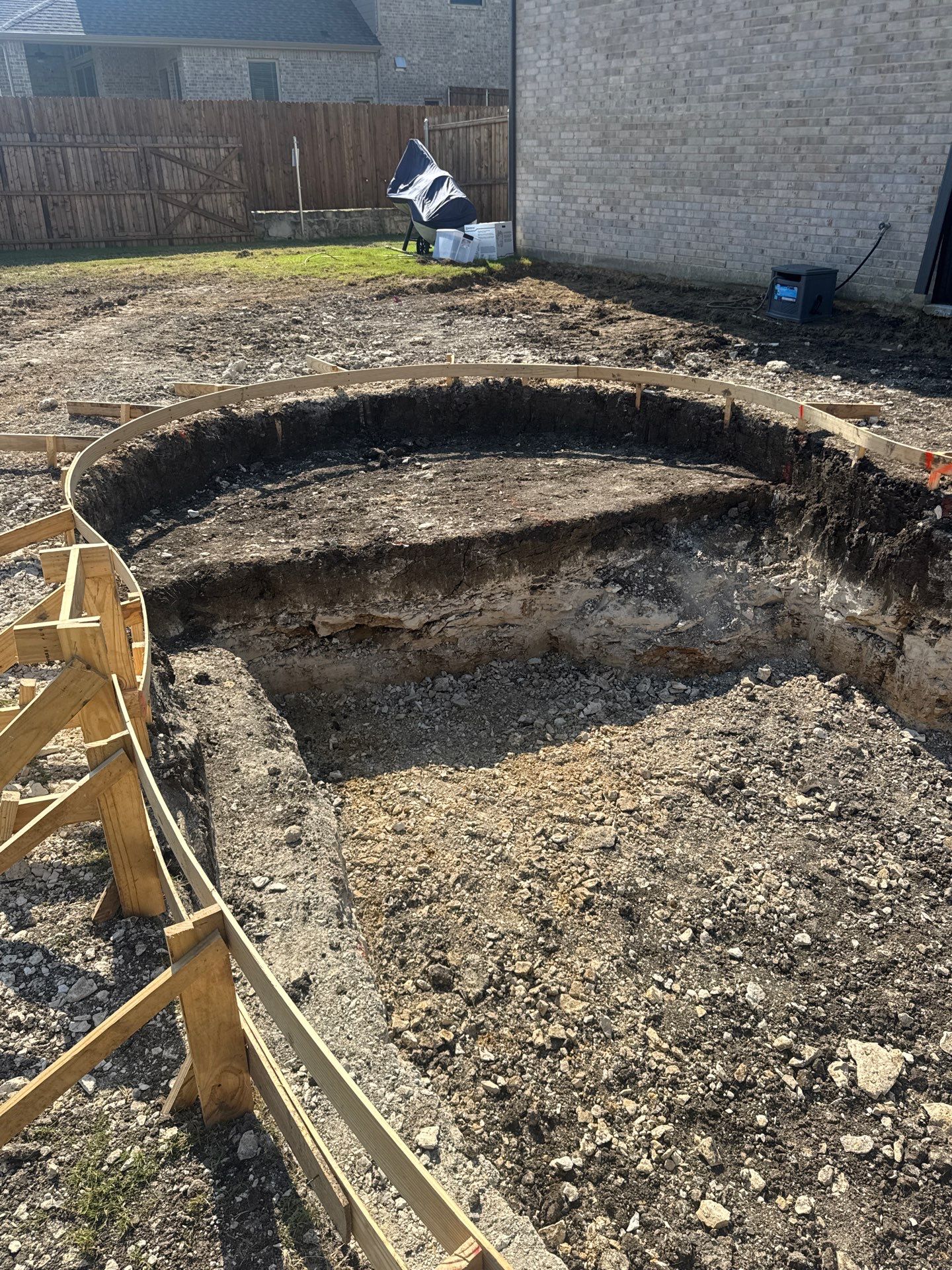 Freeform Pool with Raised Stone Accent Wall by Pinnacle Pools and Spas - DFW