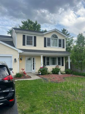 Failing vinyl siding showing wear and damage on a Crystal Lake home before replacement