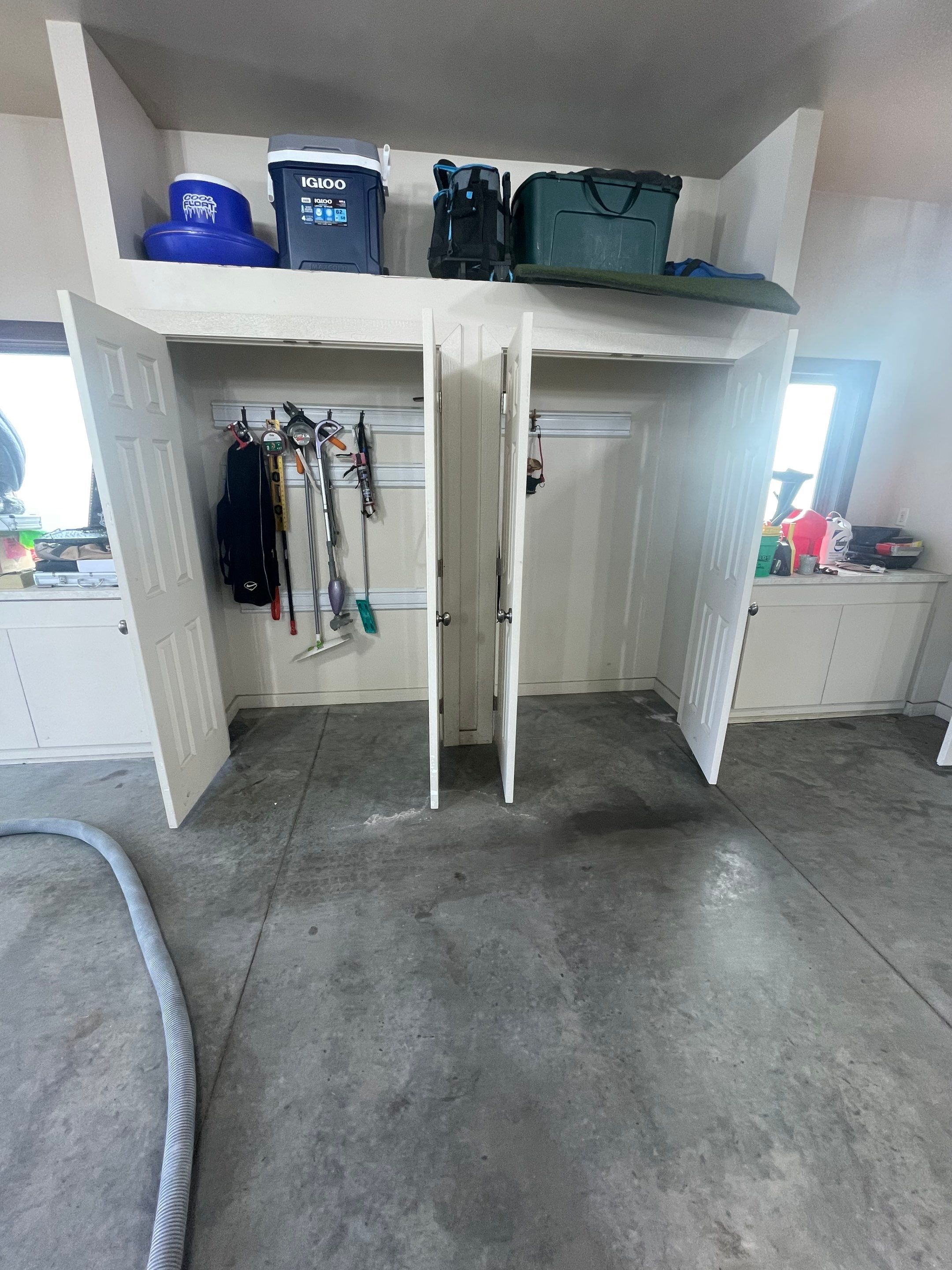 Coyote Flake Garage Floor Coating in Sioux Falls with Trench Drain by Select Painting, Coatings & Garage Cabinets