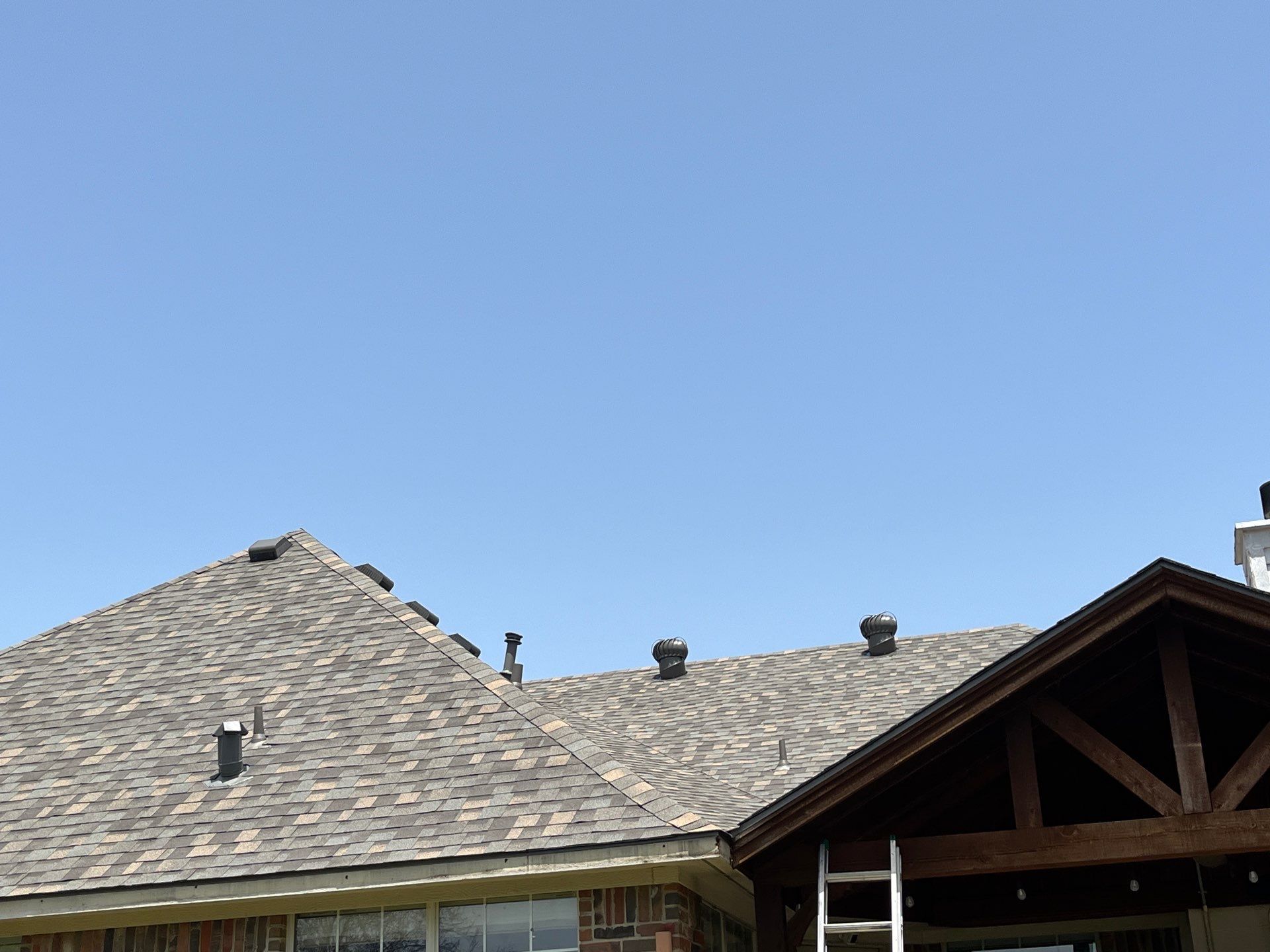 Red brick with IKO Cornerstone  by Tejas Roofworks + Restoration