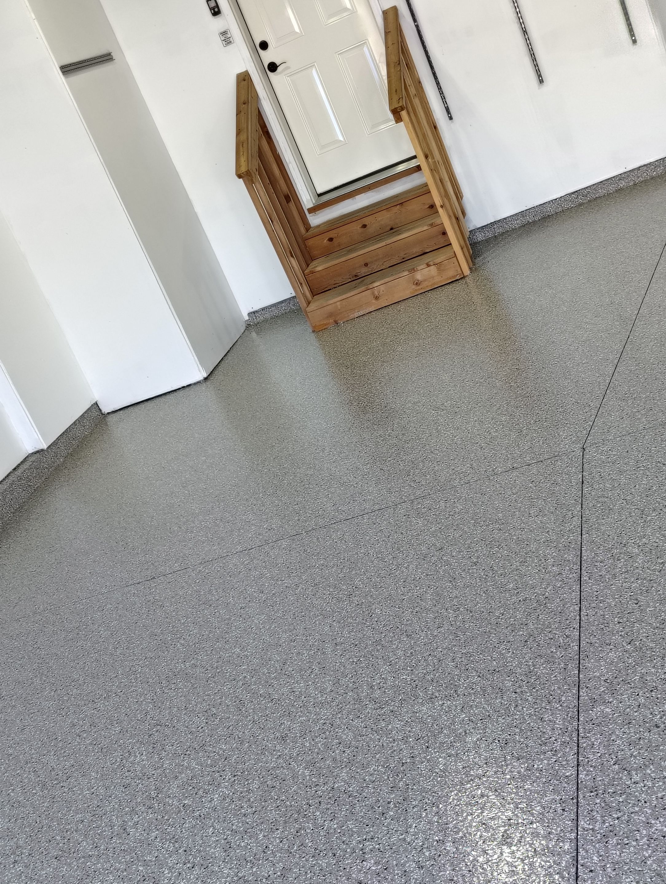 Sioux Falls Garage Floor Transformation With Gray Speckled Epoxy Coating by Select Painting, Coatings & Garage Cabinets