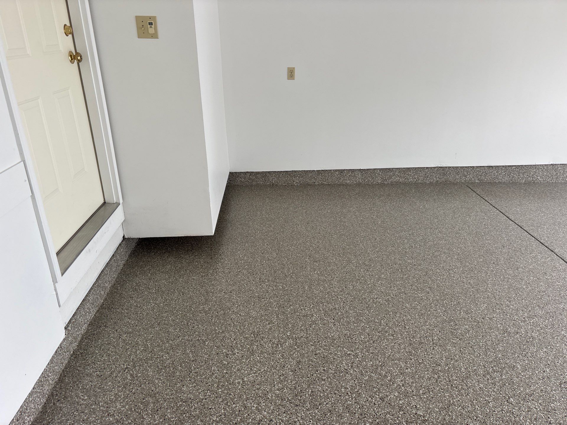 Garage floor in Holt using Smoke Flake by Freedom Concrete Coatings. 