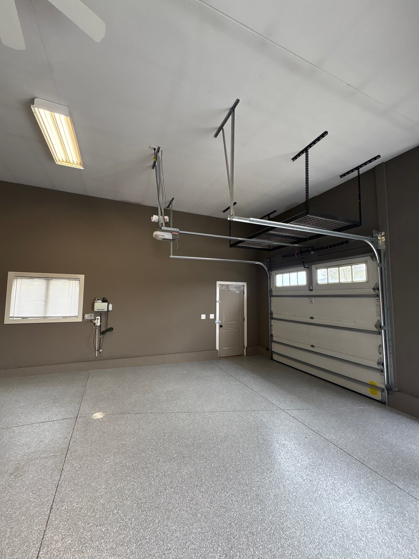 Speckled Grey Epoxy Garage Floor Coating Installation in Tea by Select Painting, Coatings & Garage Cabinets