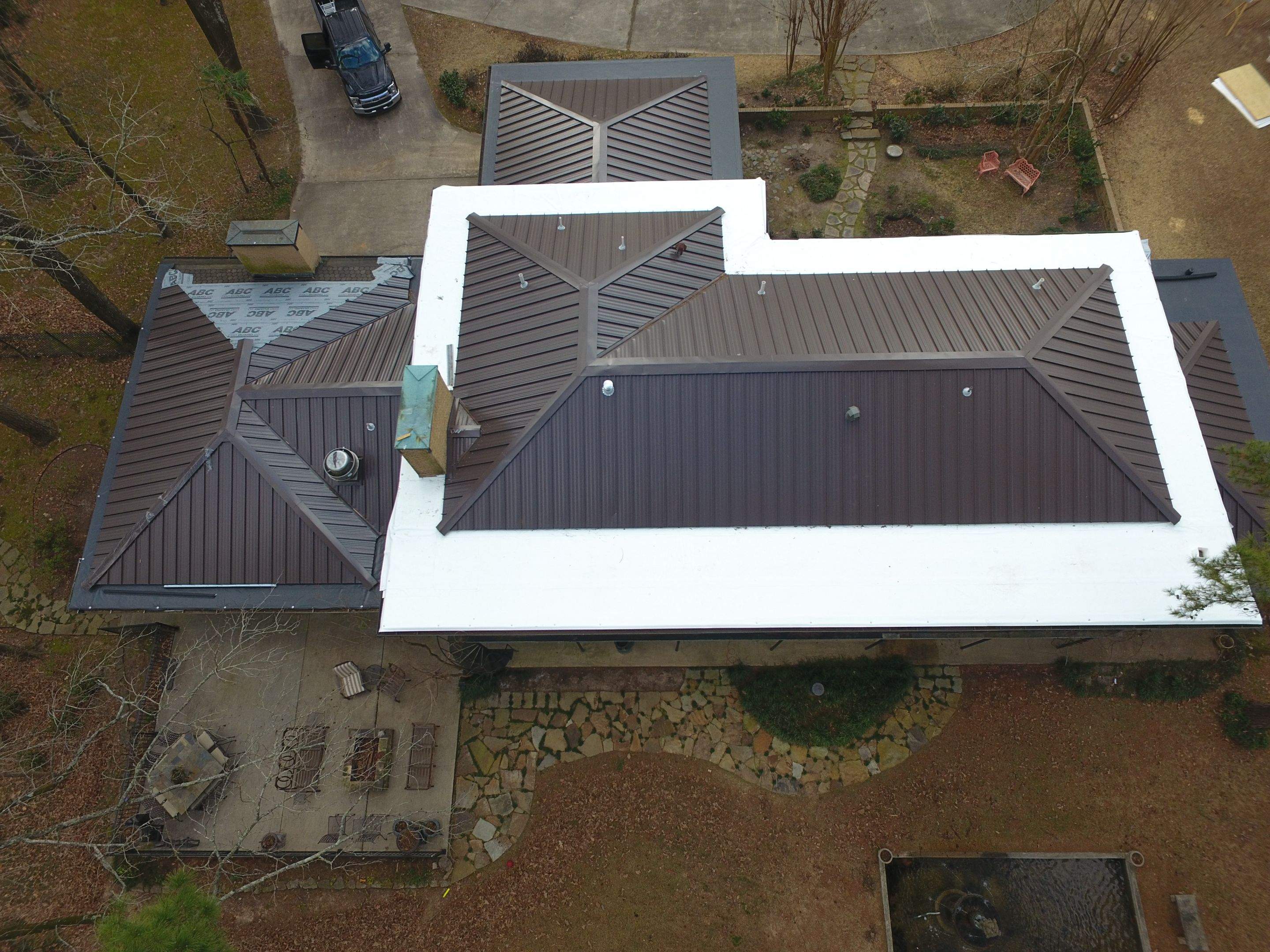 Residential Roofing Installation using PVC membrane and 24 gauge Standing Seam Metal by Hostetler Roofing
