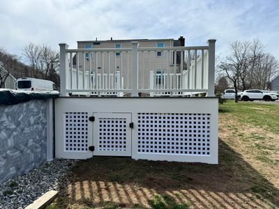 New pool deck using Trex Pebble Gray boards and White composite railings and lattice 