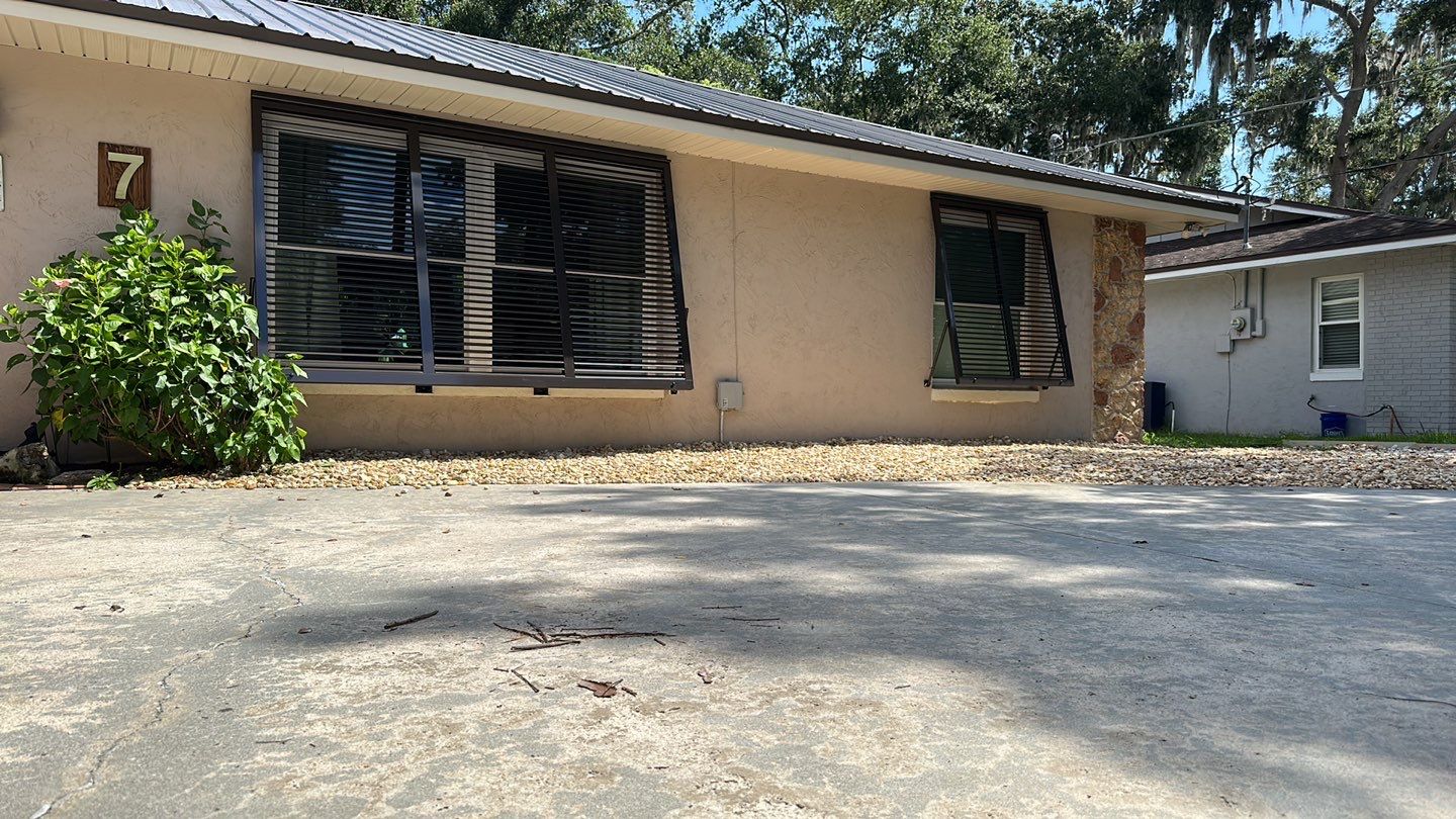 Hurricane Rated Bahama Shutters in Gray Brown by Smart Guard Shutters